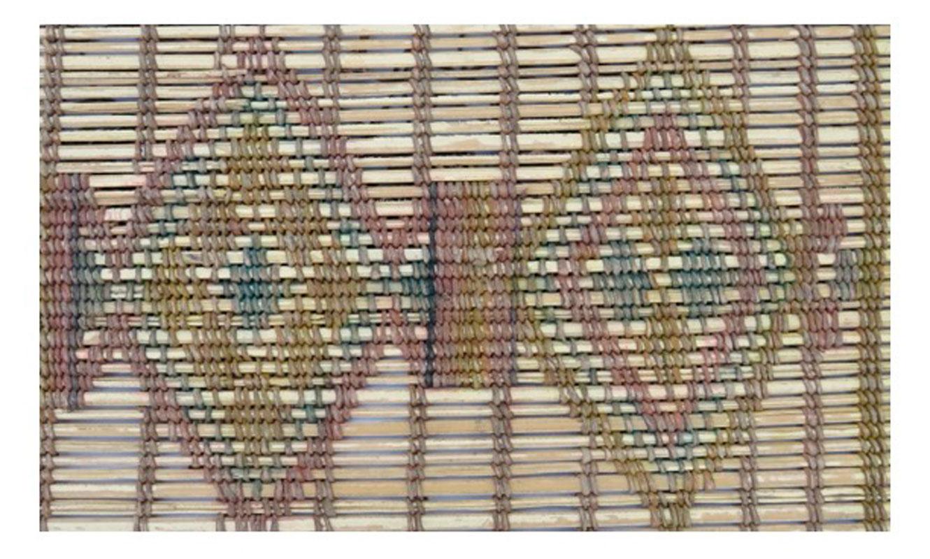 Midcentury Tuareg mat handwoven with palm reed and leather in a complex tribal design with Berber symbols. Each mat is one-of-a-kind and tells a unique story from the artisan. The design motifs are similar to those in traditional Moroccan Amazigh