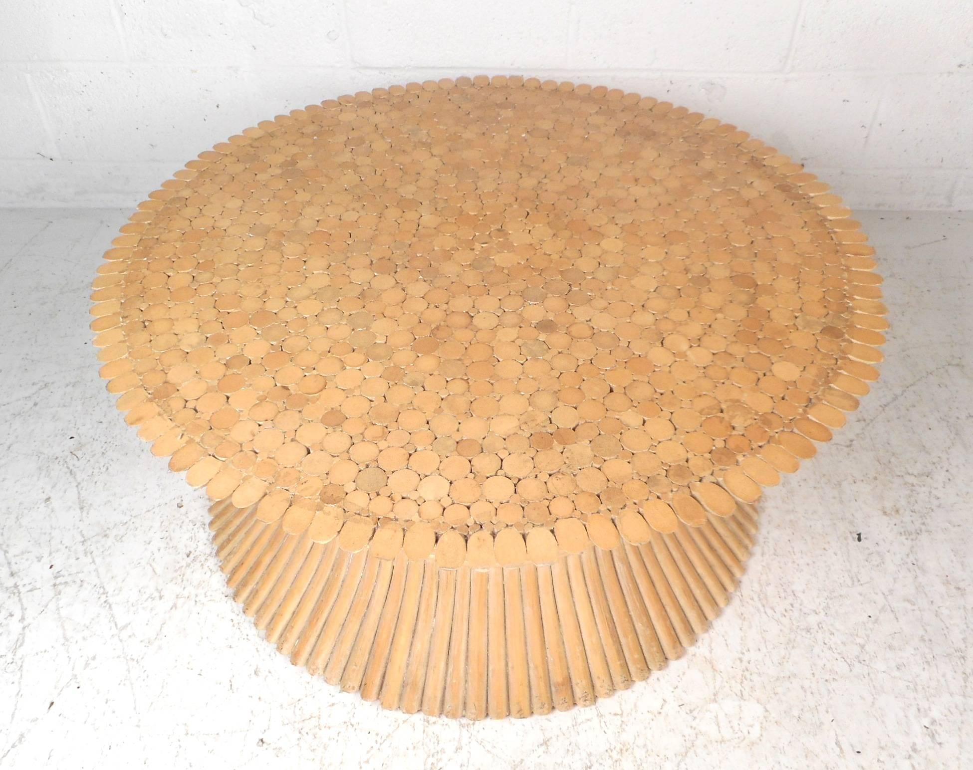 This beautiful vintage modern coffee table is made of bamboo rattan and designed by McQuire. A unique hourglass shape with a large round top and base. A versatile piece that can be used as is, or can have a round piece of glass on top. This stunning