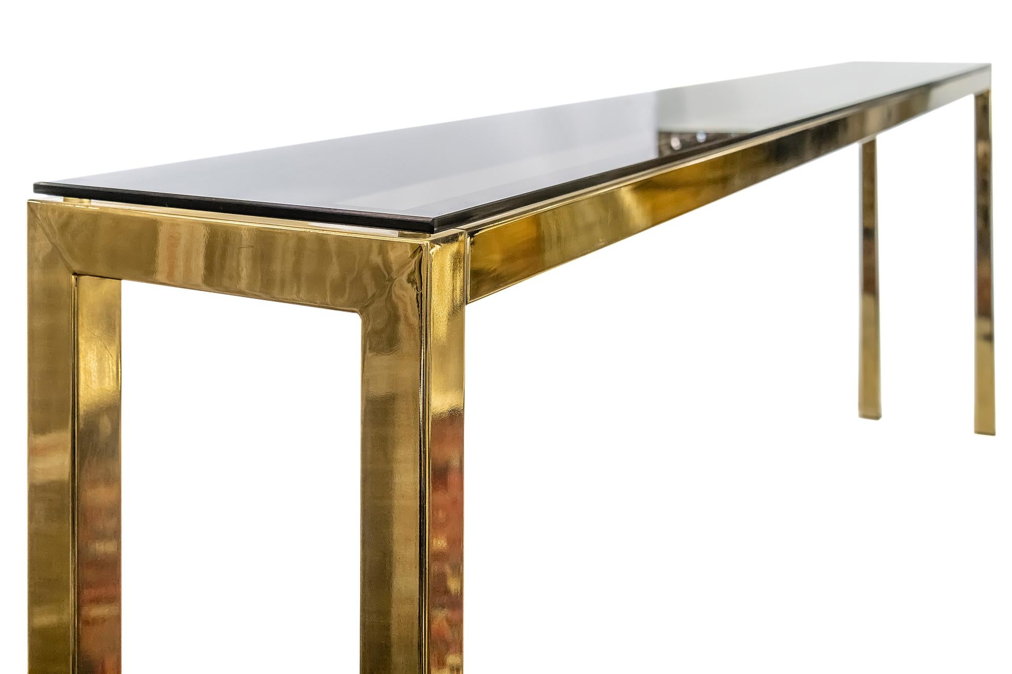 Midcentury metal and glass console table by Belgo Chrome.
Metal is brass plated.
The top glass is smoky brown color.
This console is extra long and very stabile.
 