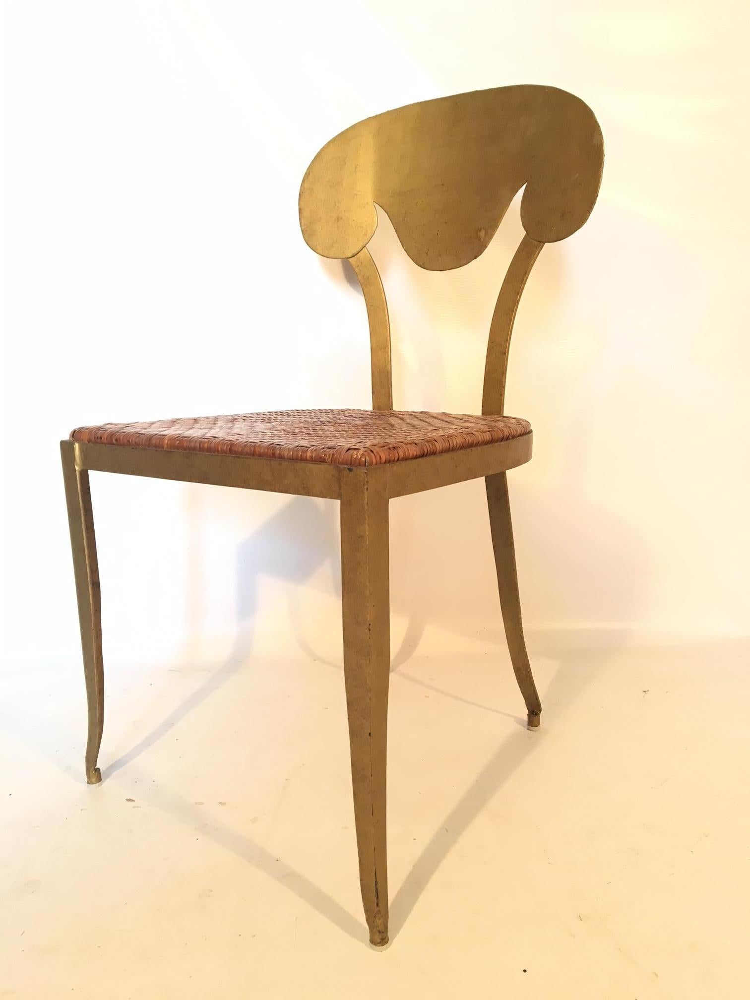 Metal vanity stool circa 1950s features rattan seat and gold gilt finish. Excellent vintage condition with only minor signs of age appropriate use.