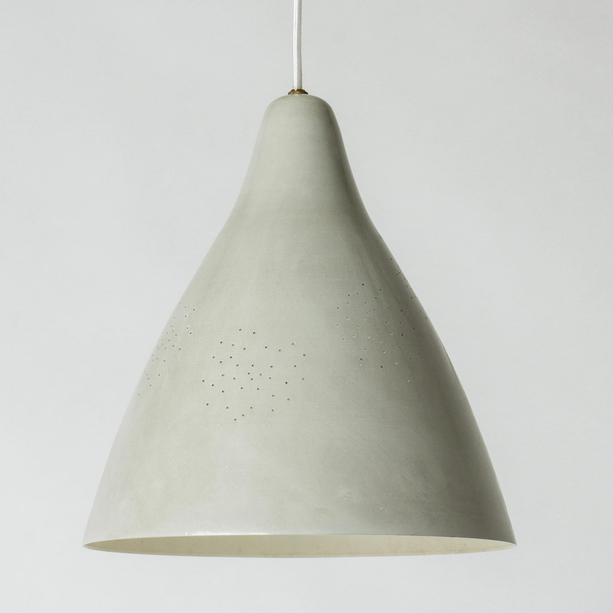 Sleek ceiling light by Lisa Johansson-Pape, made from grey lacquered metal. Voluminous form perforated with small holes that let the light out in a lovely way.