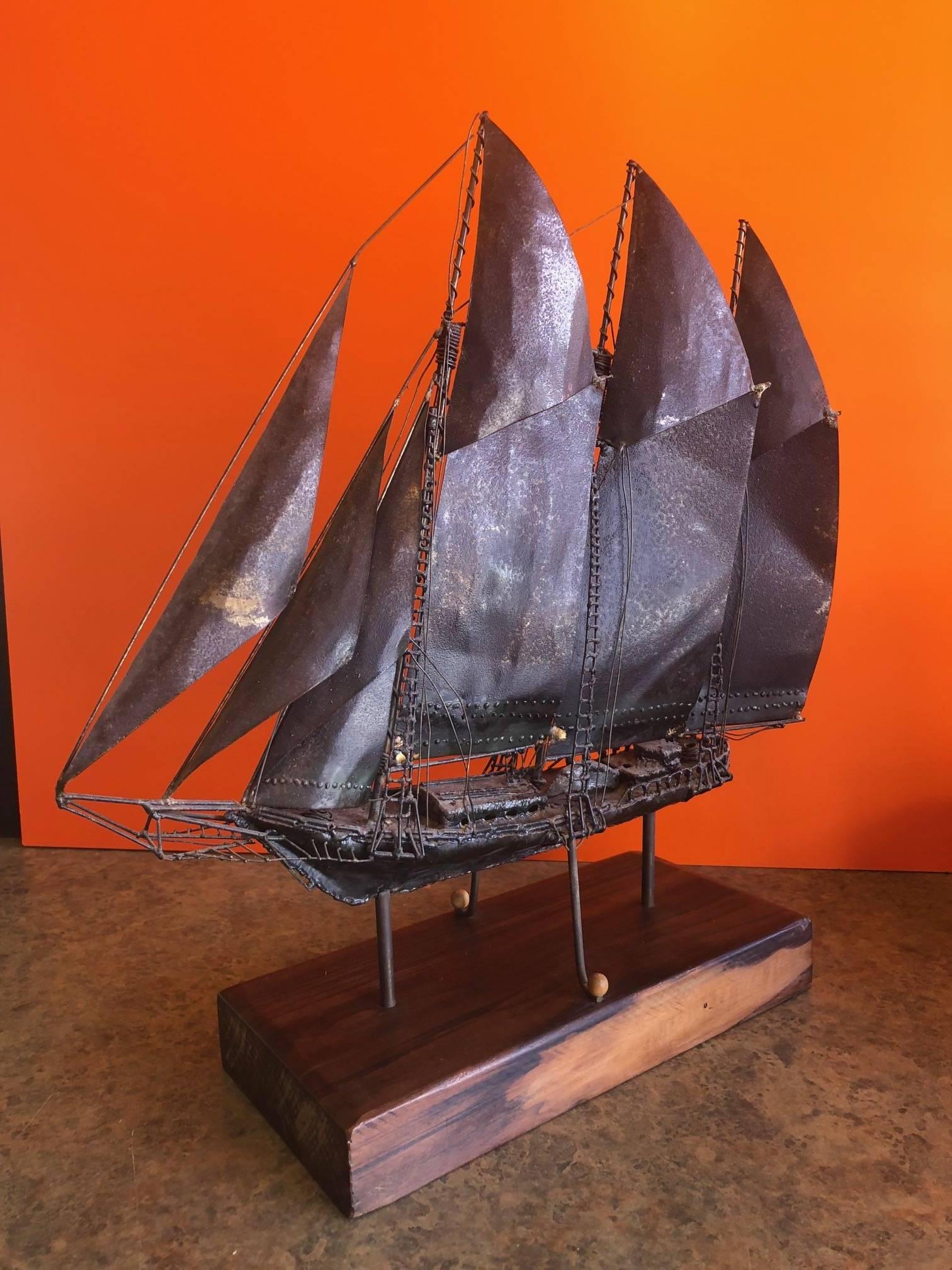 A very cool handmade metal ship on a solid wood base. The base measures 13