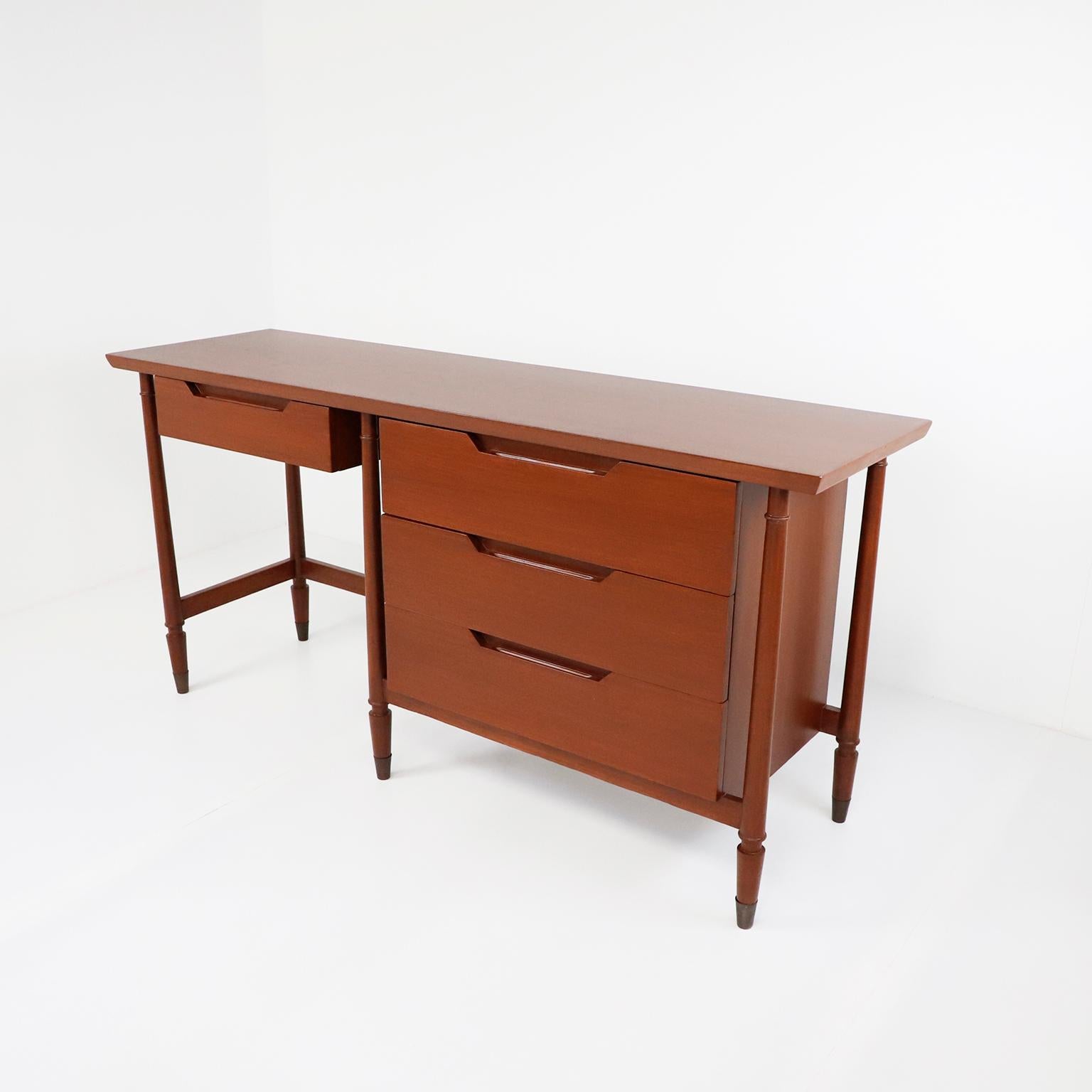 We offer this midcentury Mexican modern rare desk made in mahogany wood, recently restored, circa 1960.