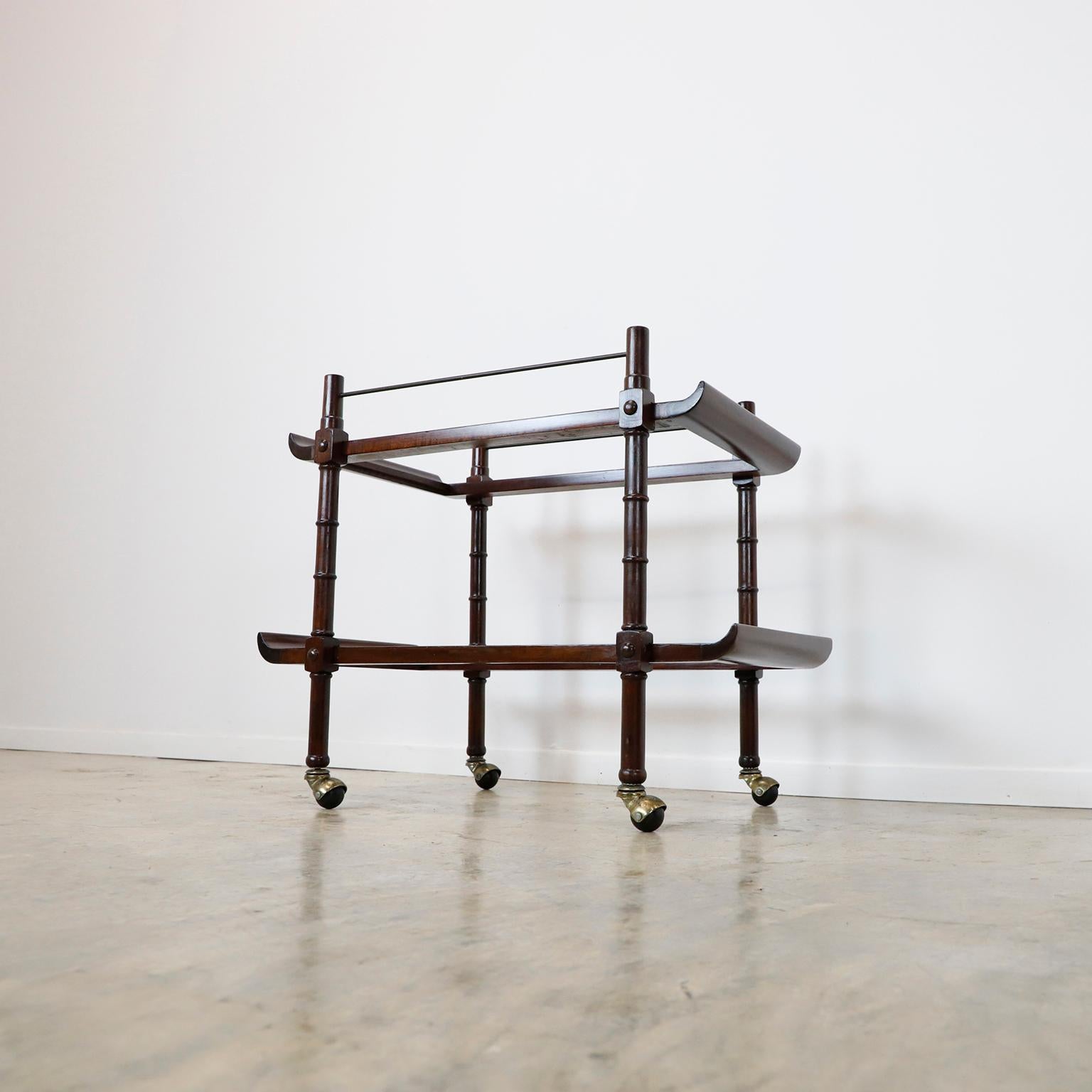 Rare rolling bar or serving cart made of mahogany and brass, designed by Frank Kyle, circa 1950. We offer this item without glass because it makes shipping over long distances easier.