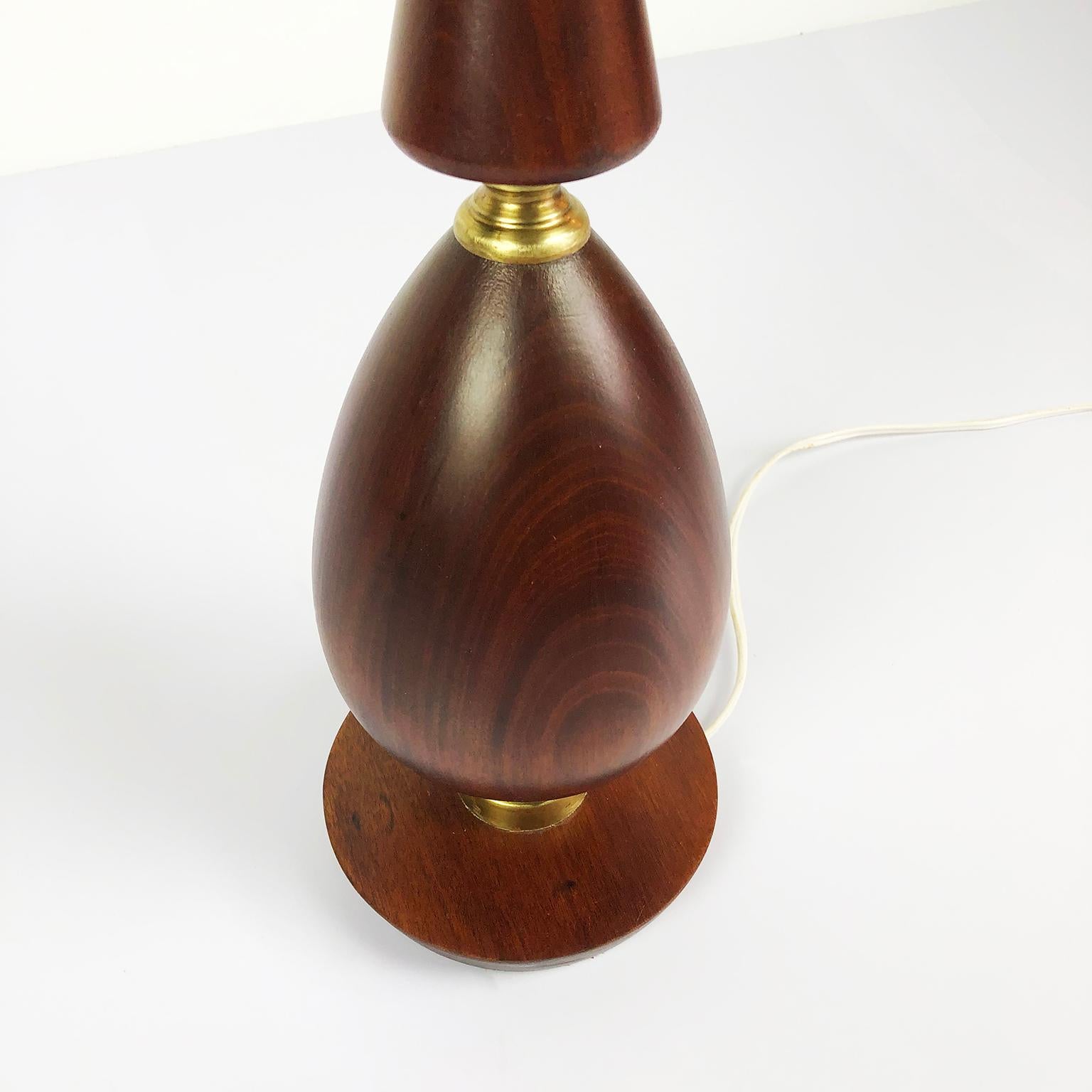 We offer this amazing a pair of midcentury Mexican modern table lamps in the style of Arturo Pani both are constructed with solid mahogany and brass accents, the lamps have been restored and rewired, circa 1950,. No shades included.