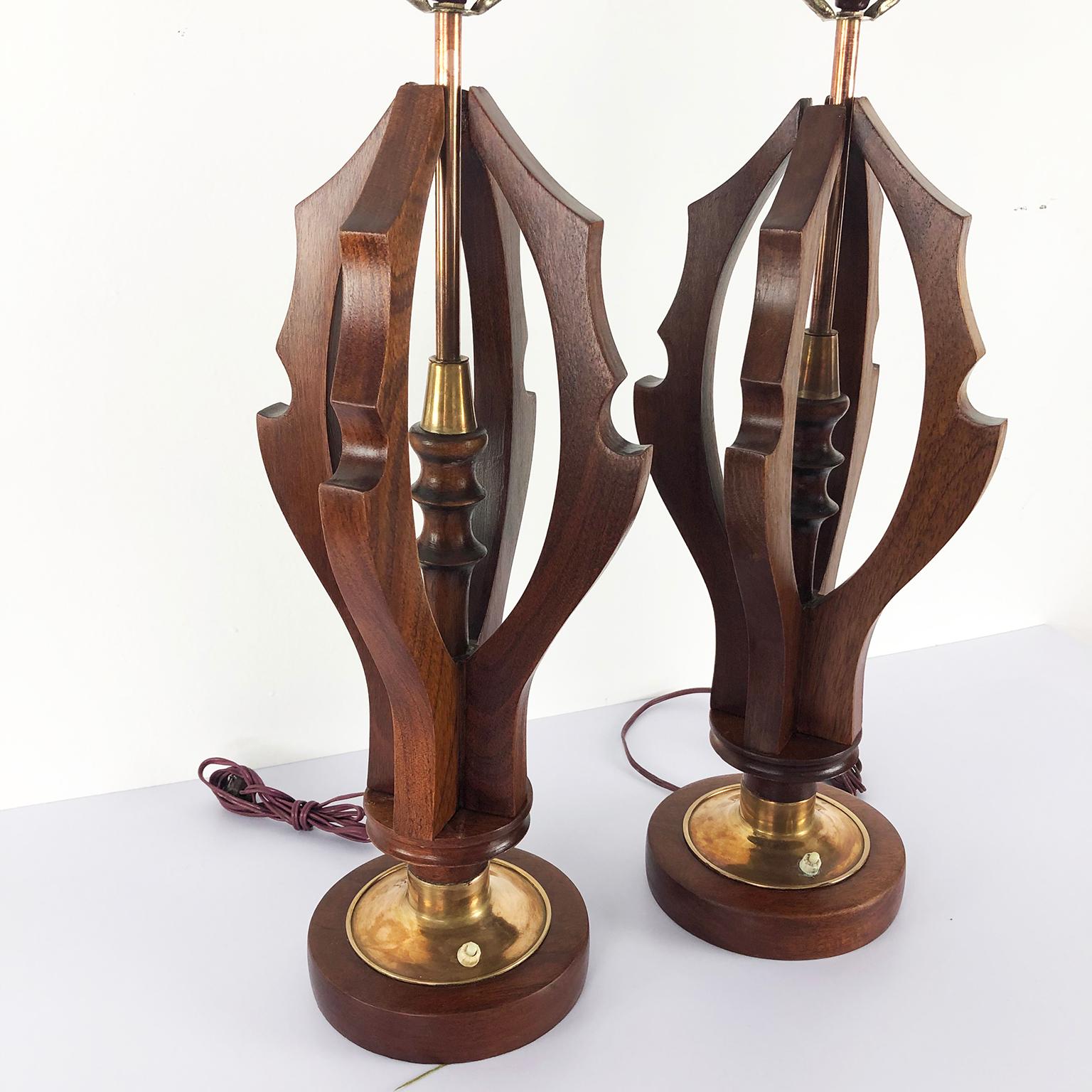 We offer this amazing a pair of midcentury Mexican modern table lamps in the style of Arturo Pani both are constructed with solid mahogany and brass accents, the lamps have been restored and rewired, circa 1950. No shades included.
