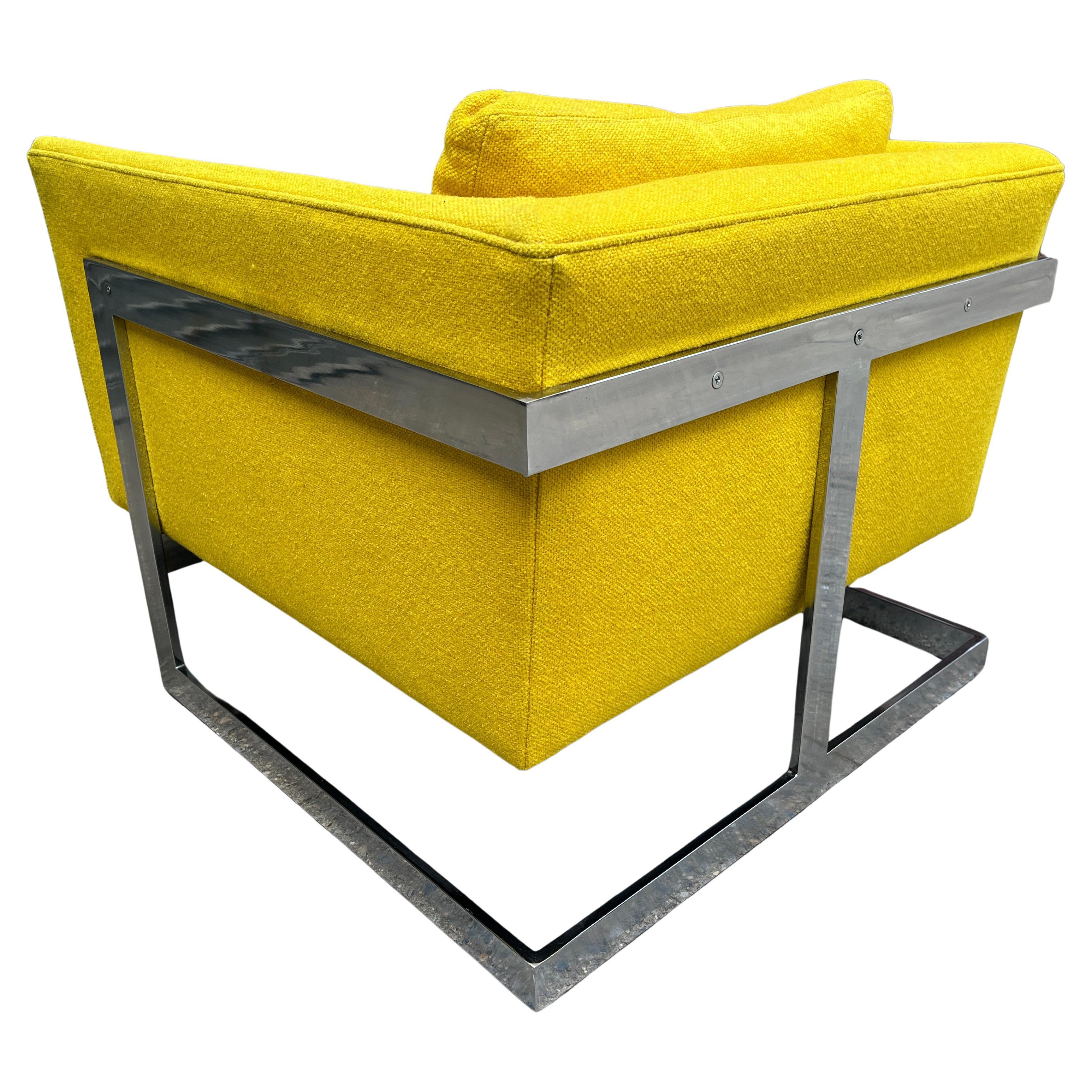 Architectural club / lounge chair upholstered in original yellow fabric by Milo Baughman for Thayer Coggin. This chair features an asymmetric chrome frame fixed to a cube seat. Cantilevered on solid flat bar chromed steel with no pitting bright and