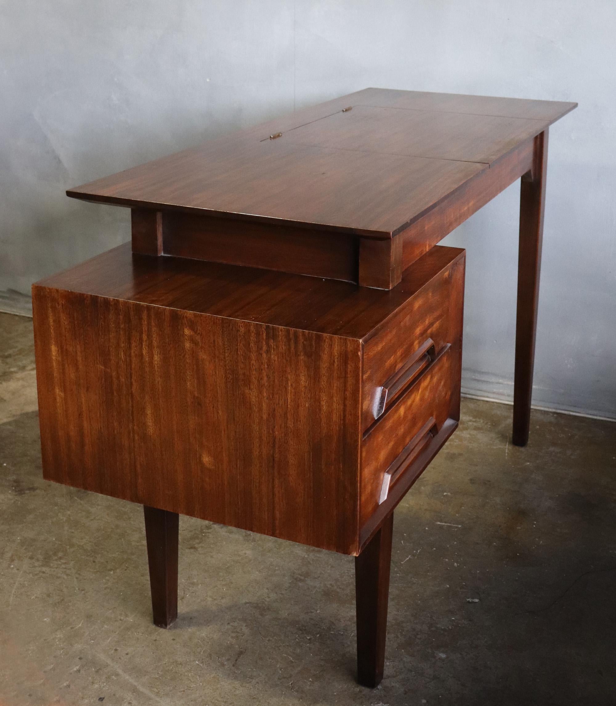 For your consideration is this rare Mid-Century Modern floating top desk from the Perspective collection by Milo Baughman for Drexel in 1951. Crafted from exotic Mindoro wood imported from the Philippines, it features a floating top with hidden