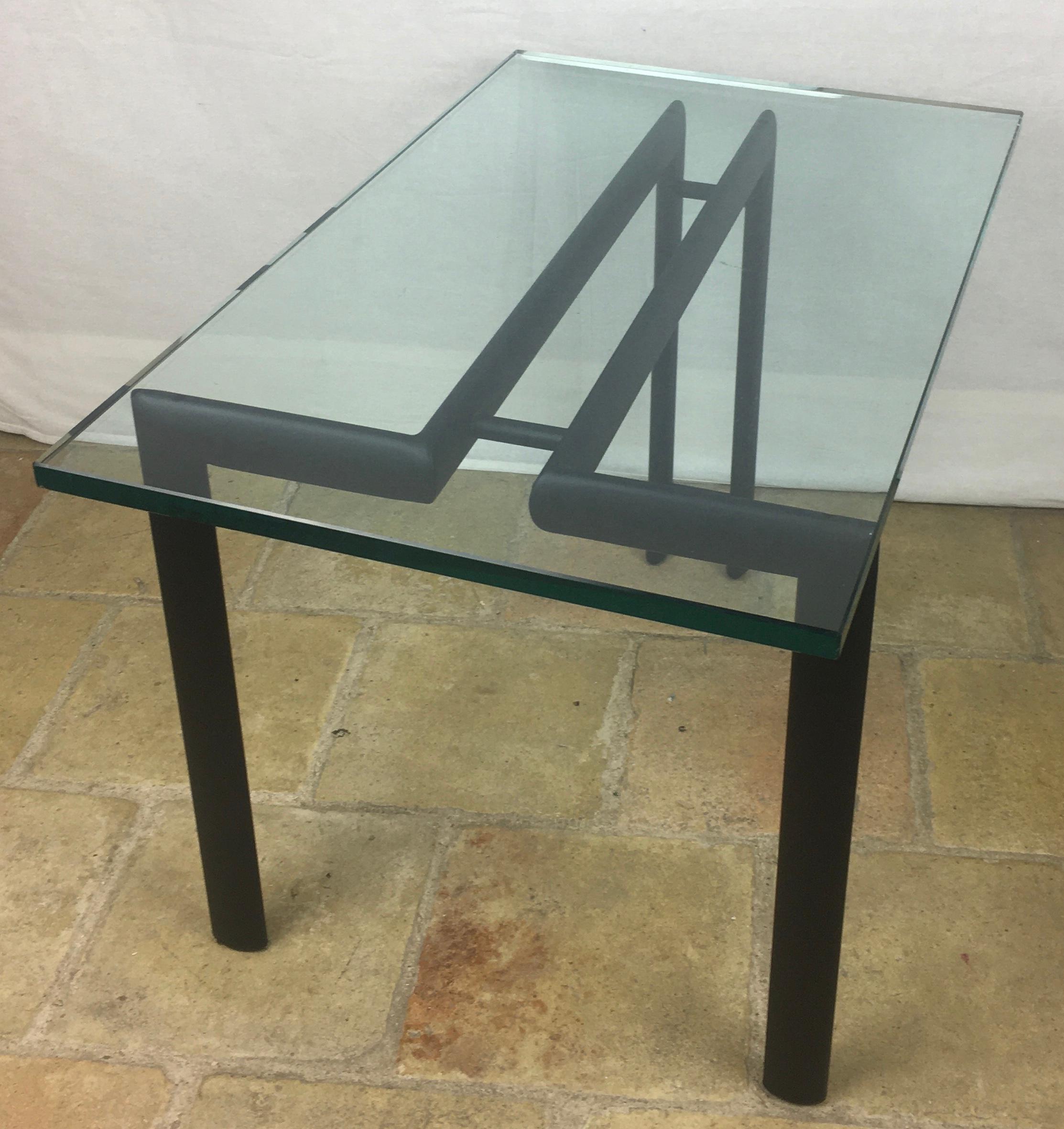A simple metal and glass end or side table. The thick, heavy glass top simply floats on the base. 

Measures: 12 1/4