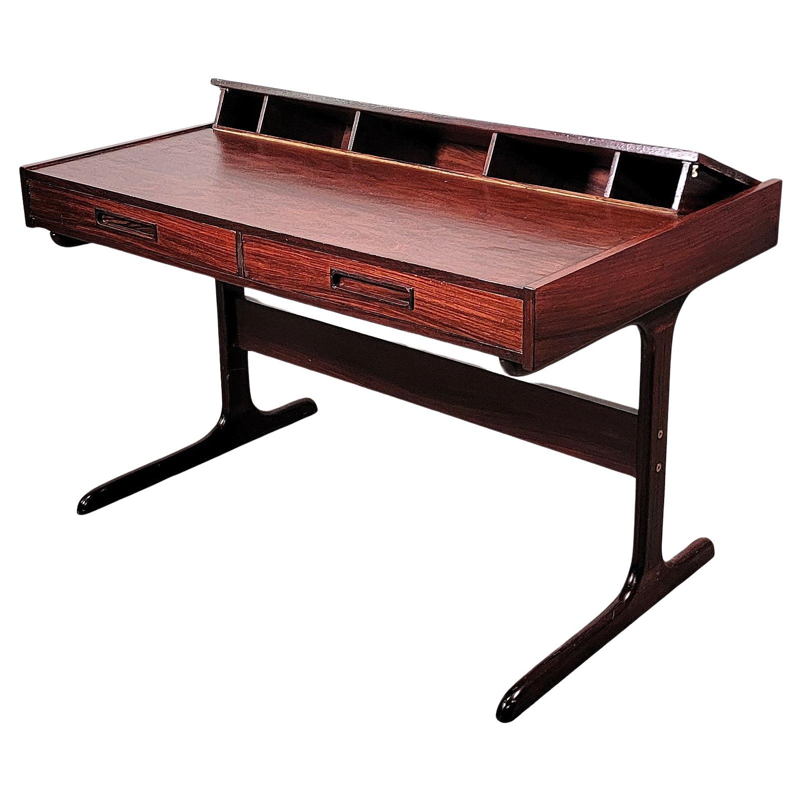 Beautiful Danish desk or vanity table featuring highly figured rosewood on a rectangular form with 2 front drawers, and a solid rosewood trestle base. The writing table has a pop up 5 cubby organizer, 11