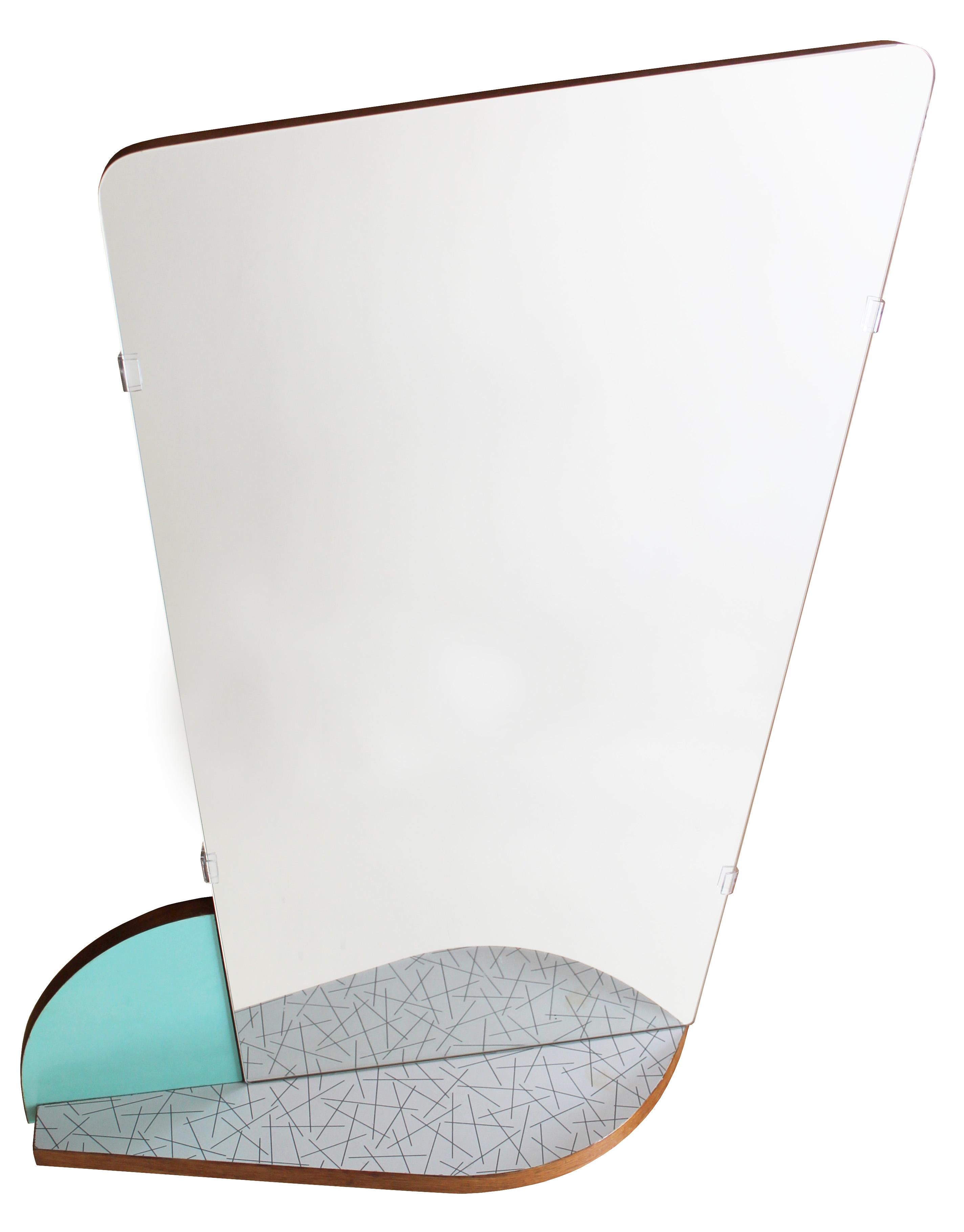 This unique Czech midcentury mirror is a composition of shapes made up of a patterned formica shelf, a turquoise segment and an asymmetric mirror. 

This mirror perfectly embodies the elegance of the so-called Brussels Style, named after Expo 1958