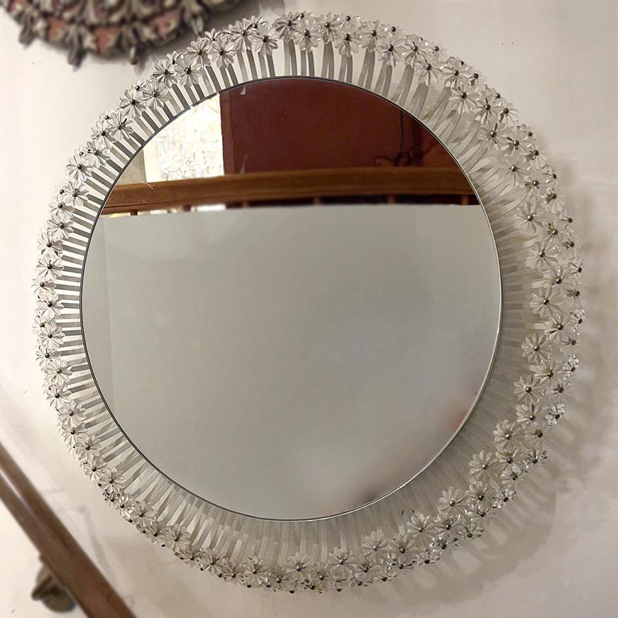 A circa 1960s Swedish mirror with 6 interior lights.

Measurements:
Diameter: 23