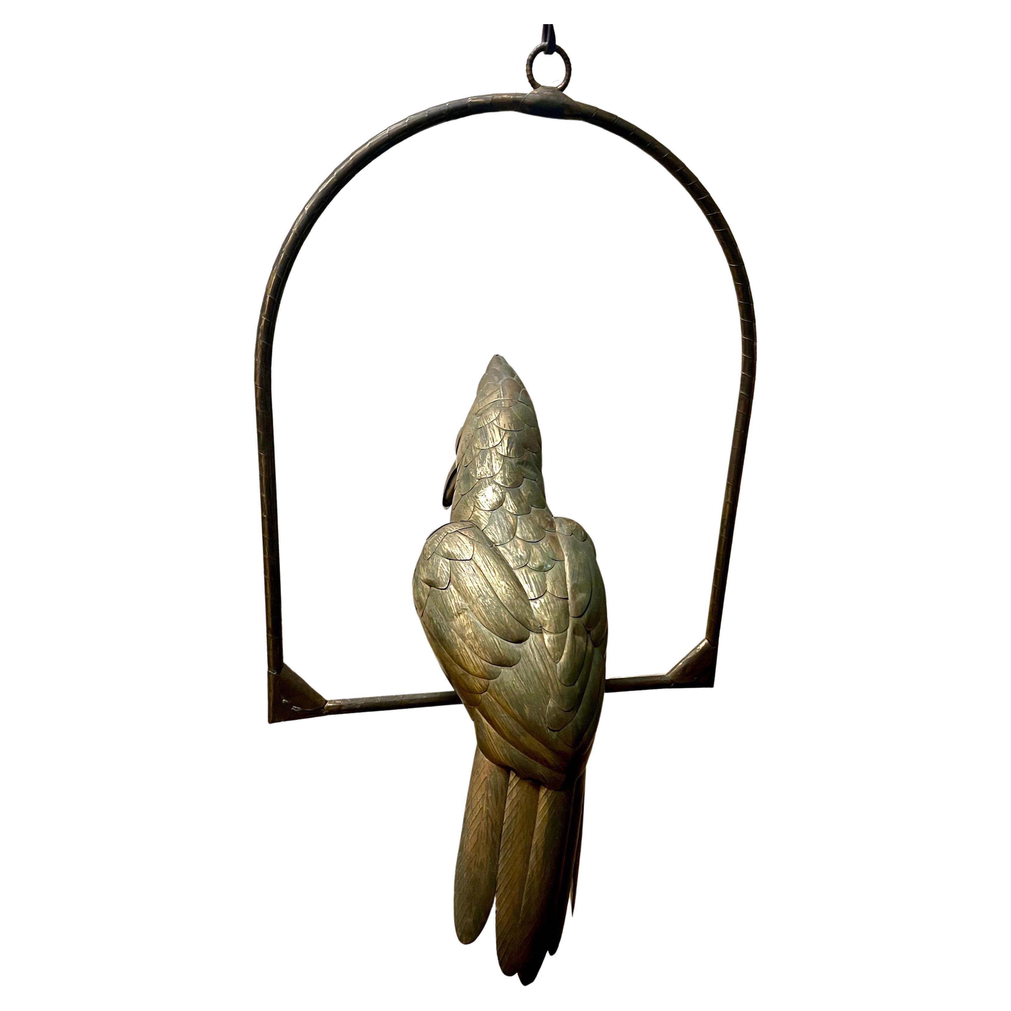  mixed metals (copper, brass parrot bird sculpture on a hanging perch by noted Mexican artist, Sergio Bustamante, circa 1970's. Nice patina small dent due to age can be polished .
