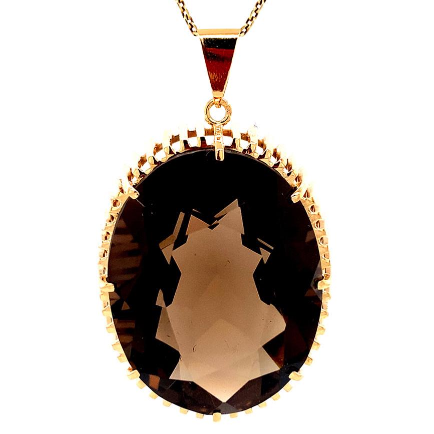 A statement smoky quartz is mounted in the most stylish of jewels - eight gold prongs hold the gemstone above a sculptural, geometric mounting. The smoky quartz is  measures 30.2 mm x 23.2mm and would look simply fabulous on a torque choker, or