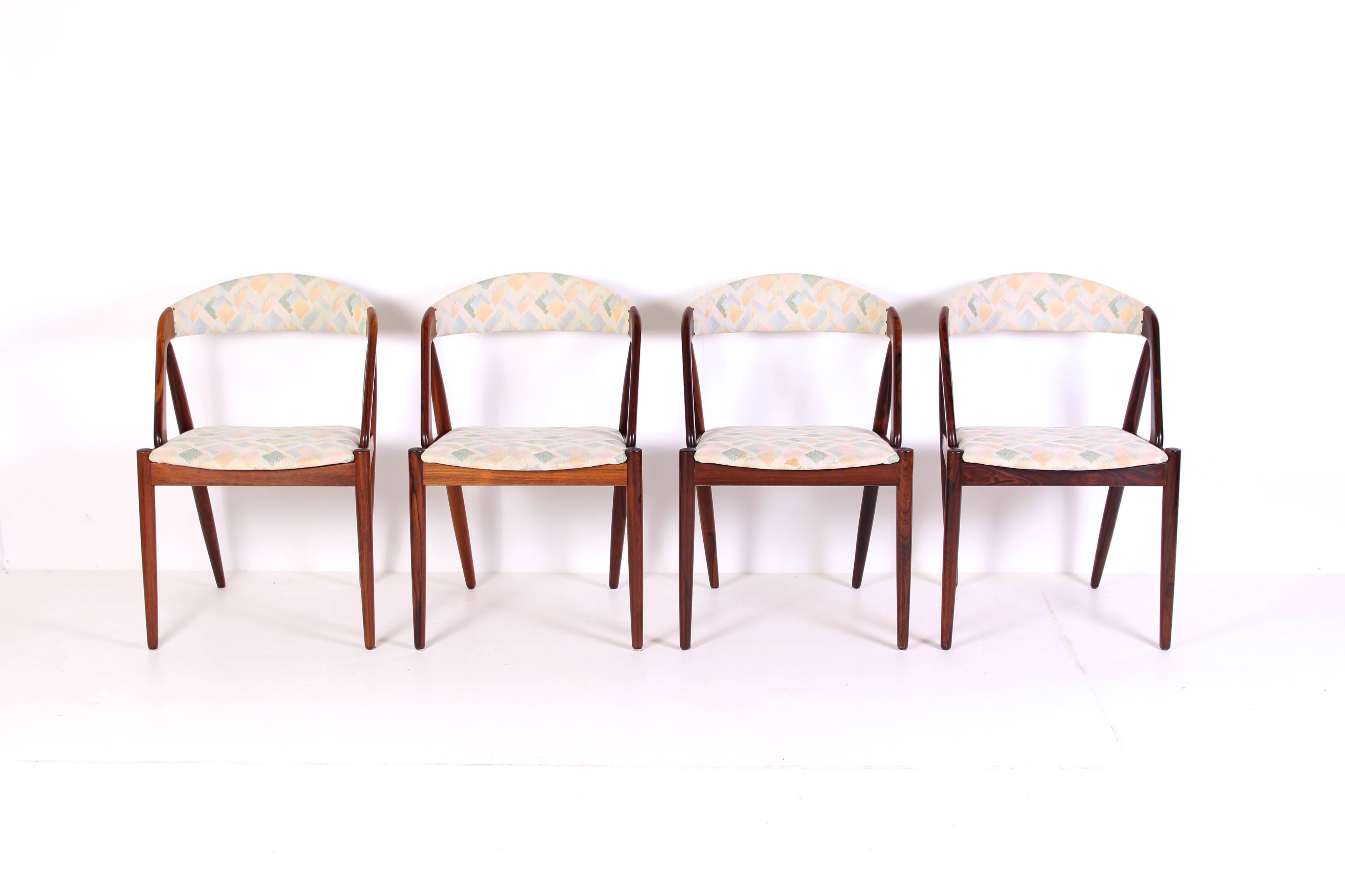 A set of four rosewood dining chairs by Danish designer Kai Kristiansen. The chairs are in very good vintage condition (smaller fading of color related to age) with fabric with only very small signs of usage.