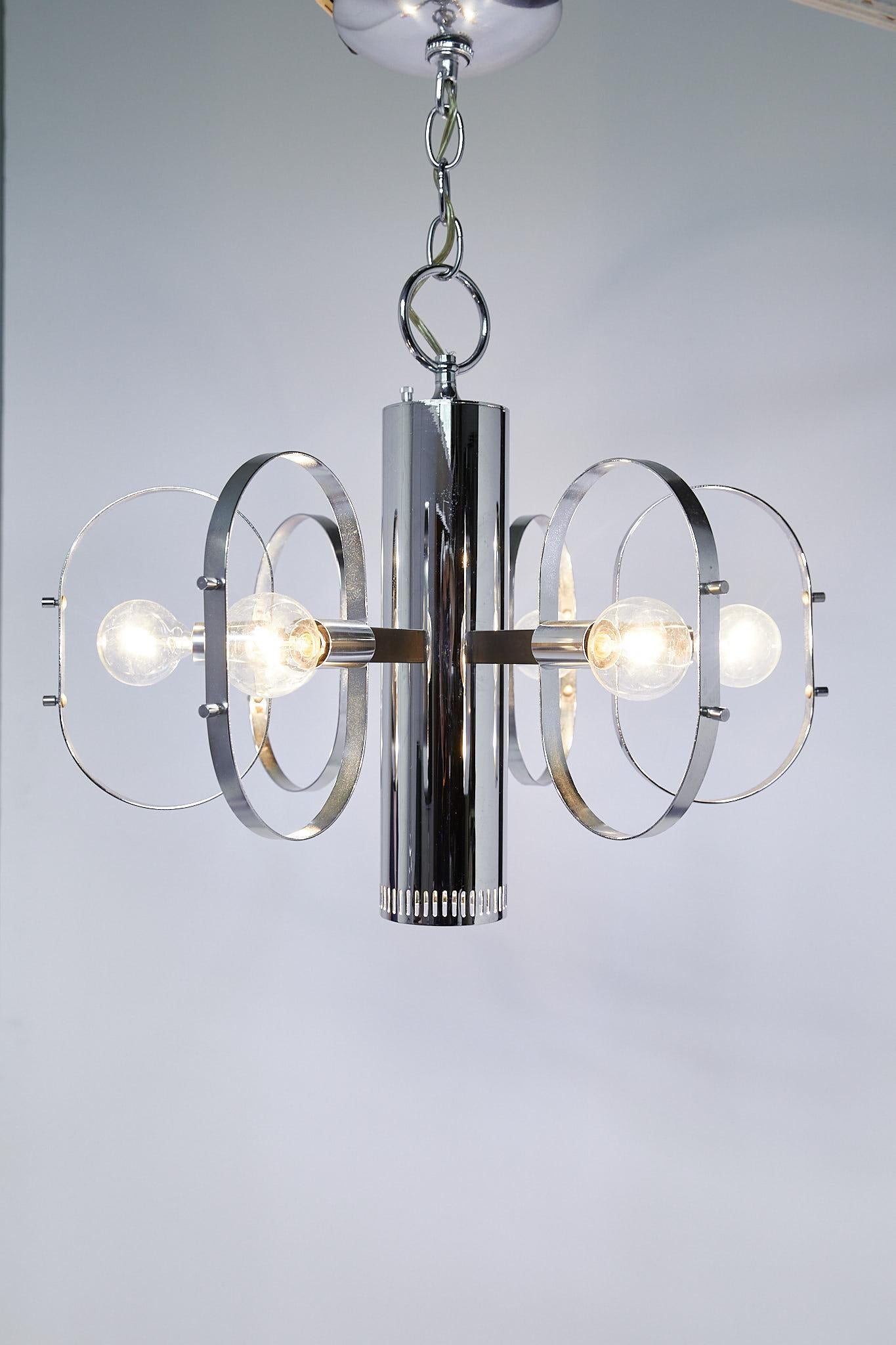 Great quality midcentury light fixture by Forecast Lighting having a tubular pendant with hidden downward facing light and six lights around the perimeter framed by metal orbs. The fixture is on a three way switch so that you can turn on the bottom