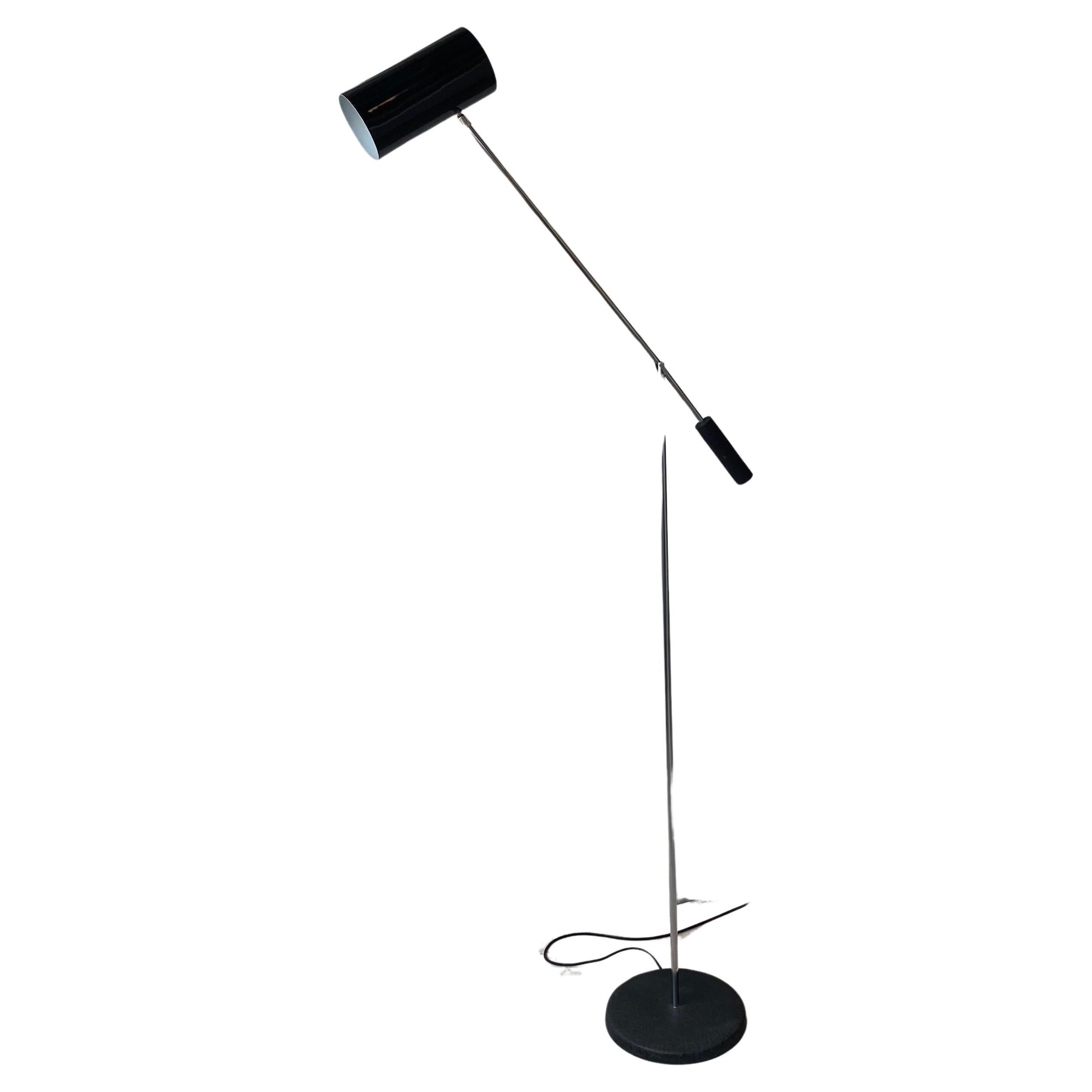 Circa 1970s chrome and black can/base cantilever floor lamp.
Black metal can shaped shade that fully articulates on an adjustable arm.
Arms can be raised or lowered and secure with chrome knob at junction.
Midcentury modern design attributed to