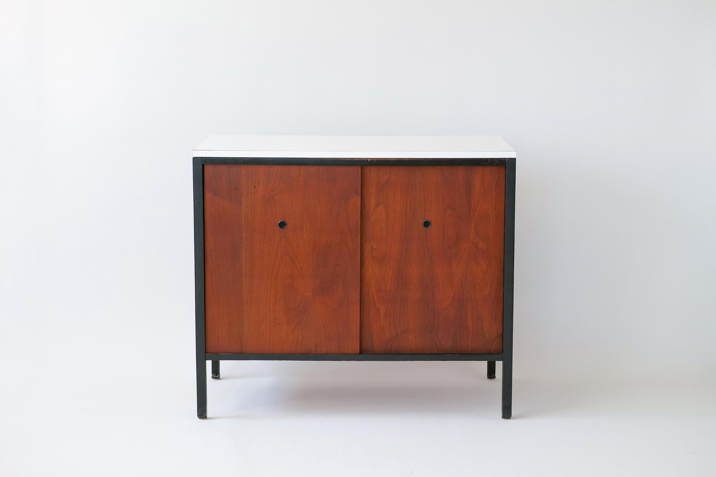 For you consideration is this rare L10 Cabinet by Allan Gould featuring walnut case with original oiled finish; ebonized interior with adjustable shelf; finished back; and original white plastic laminate top.