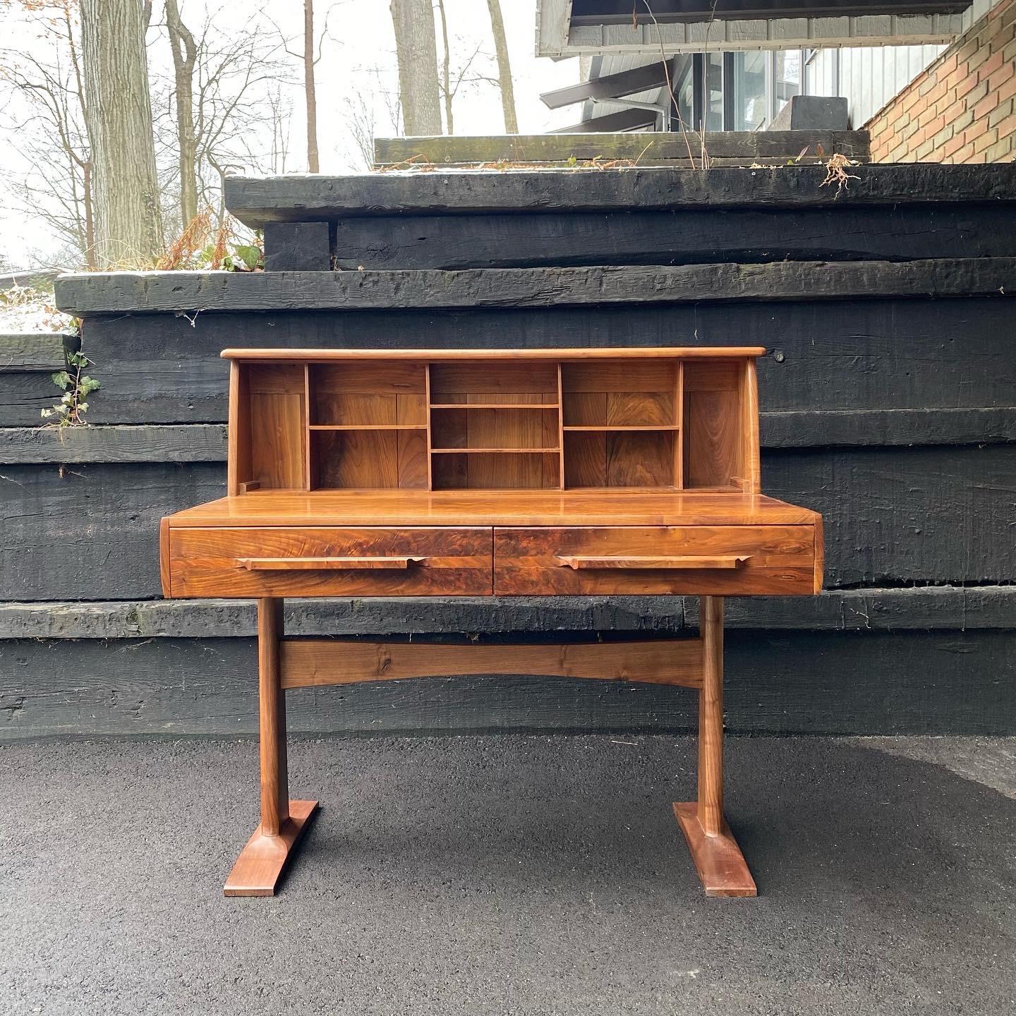 This is a beautiful handmade solid walnut studio craft desk, ca. 1965. It’s got wonderful dovetailed features on each end and a beautiful shelf with room for storage. The two drawers run the depth of the piece for large amounts of storage. The piece