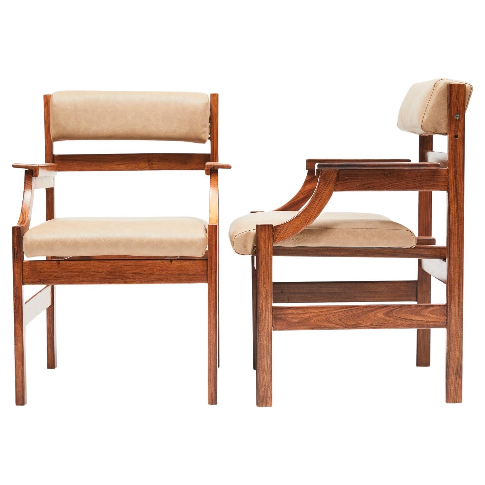 Available immediately, these Mid-Century Modern Armchairs in Hardwood & Faux Leather, are stunning!

The armchair structure has straight lines and is made entirely of Caviuna wood, a favorite one for designers like Giuseppe Scapinelli and Rino