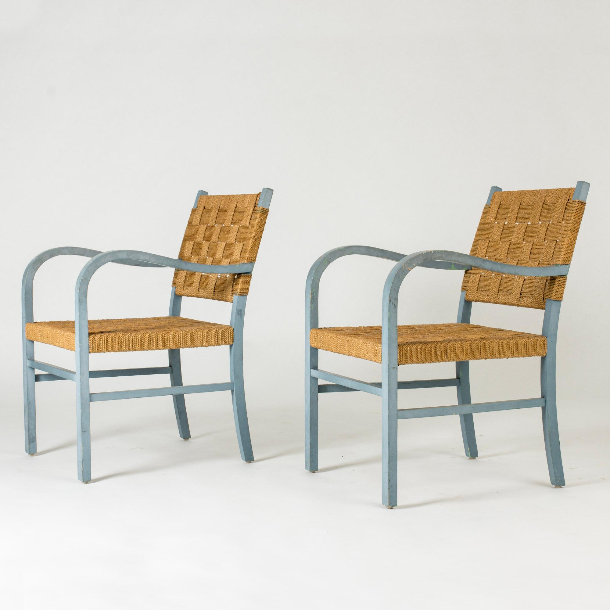 Pair of beautiful armchairs by Axel Larsson, with curved armrests creating lovely, open silhouettes. Painted sky blue, color losses from wear.
