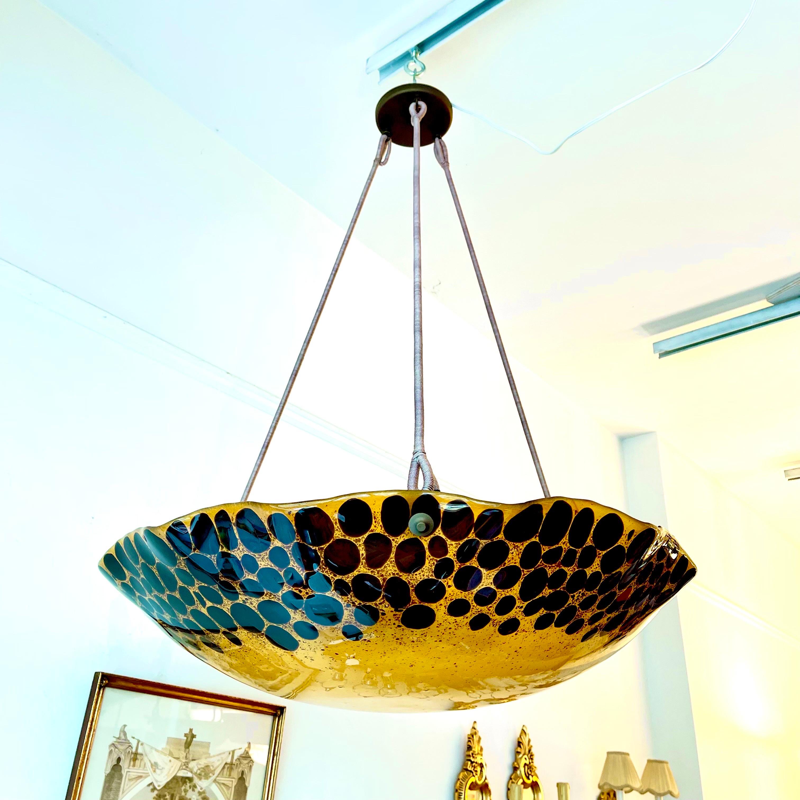 Formidably sized fixture will serve as a centerpiece and main light source for large rooms. A cloud of amber glass floats with brown leopard spots and suspends 6 full size lightbulbs (100W max per bulb). Drop may be altered at no additional charge.