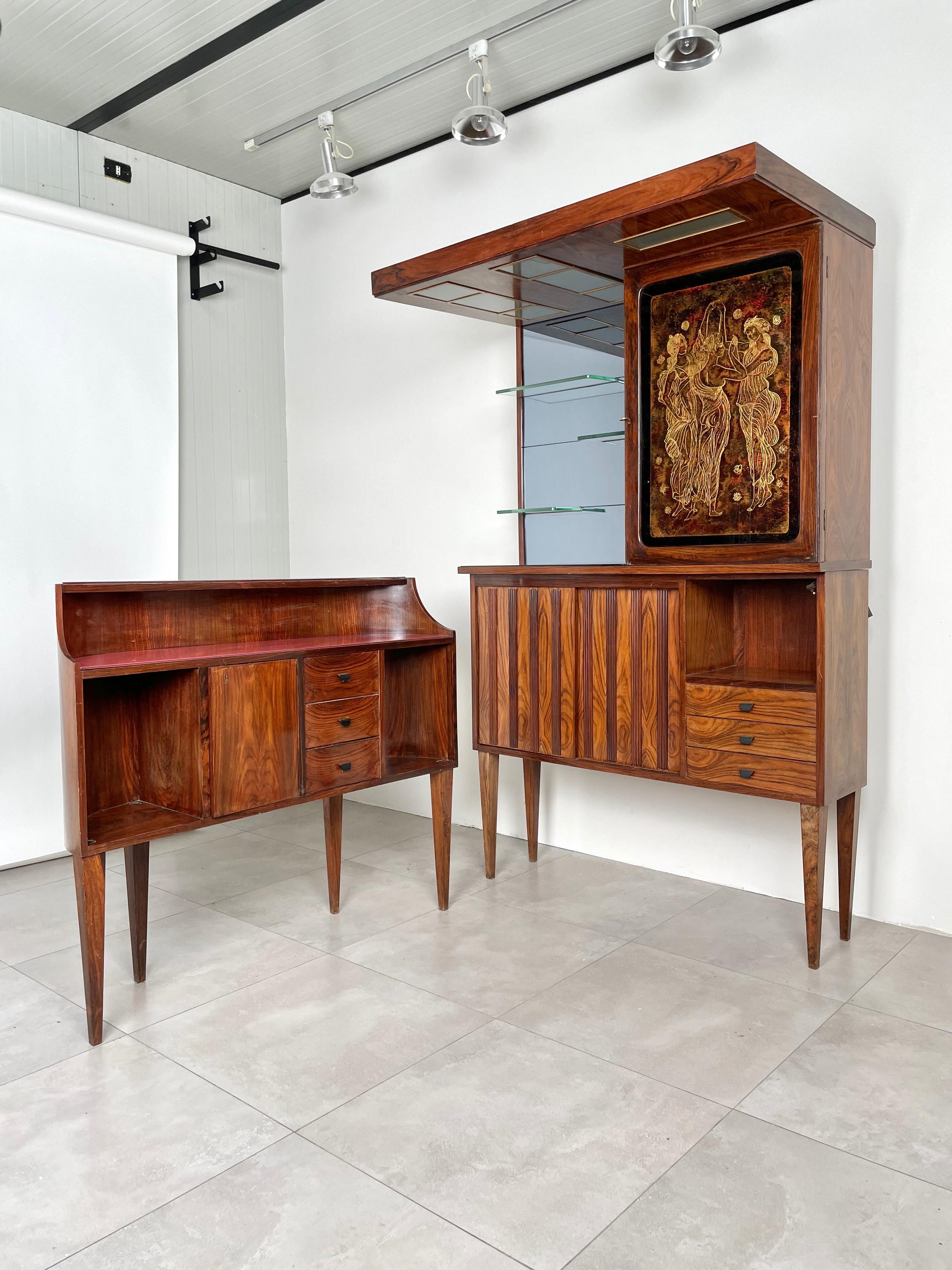 Mid-Century Modern Italian bar cabinet in rosewood and glass with the peculiarity of being composed of two separate units. 

The larger one is a wall unit characterized at the top left by a smoked glass mirror with three shelves and at the top