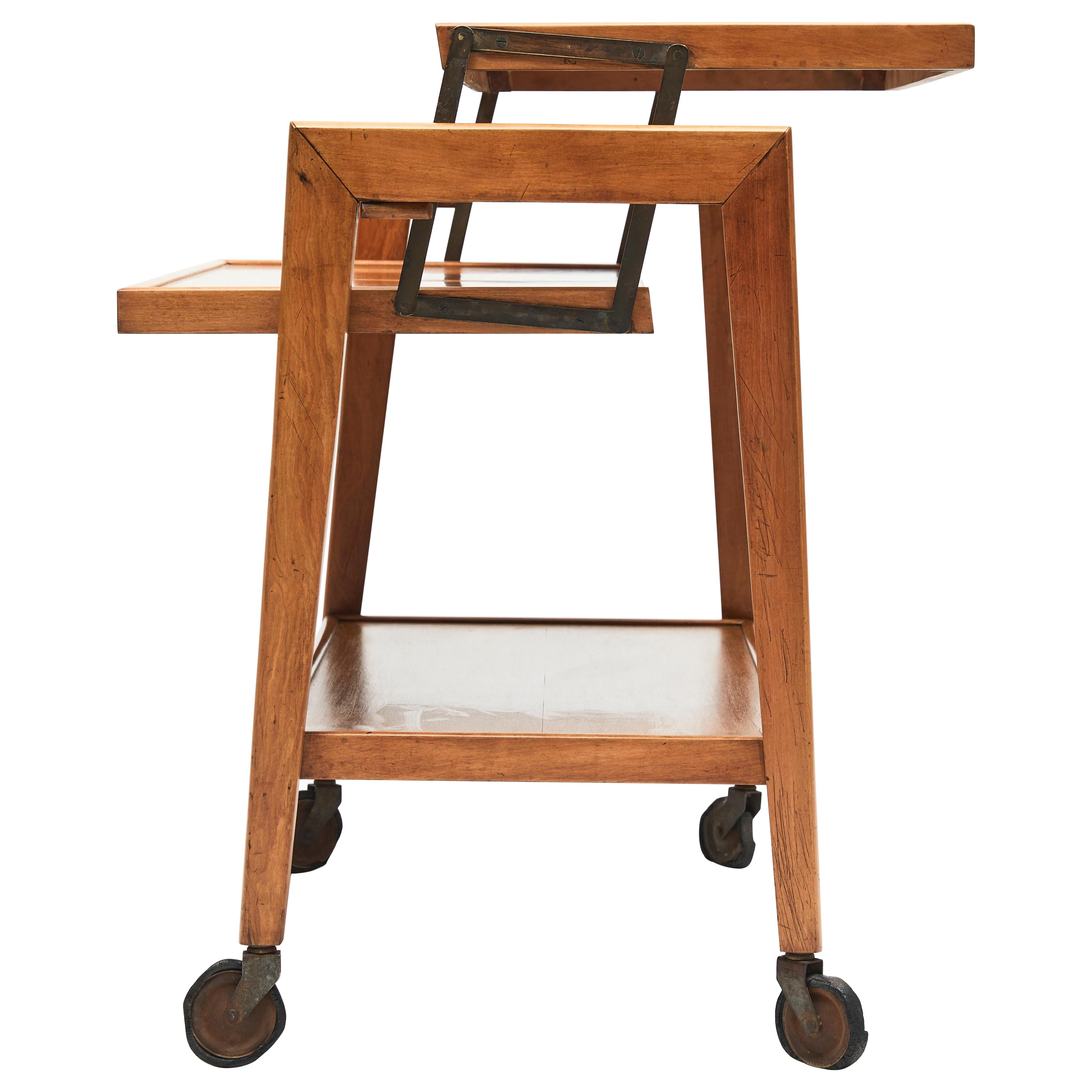 Available today, this Mid-century bar cart in Pau Marfim hardwood & brass is stunning! Its unique design, for the time, draws attention for its functionality and practicality. It has 3 different positions: Closed is an elegant bar with two levels.