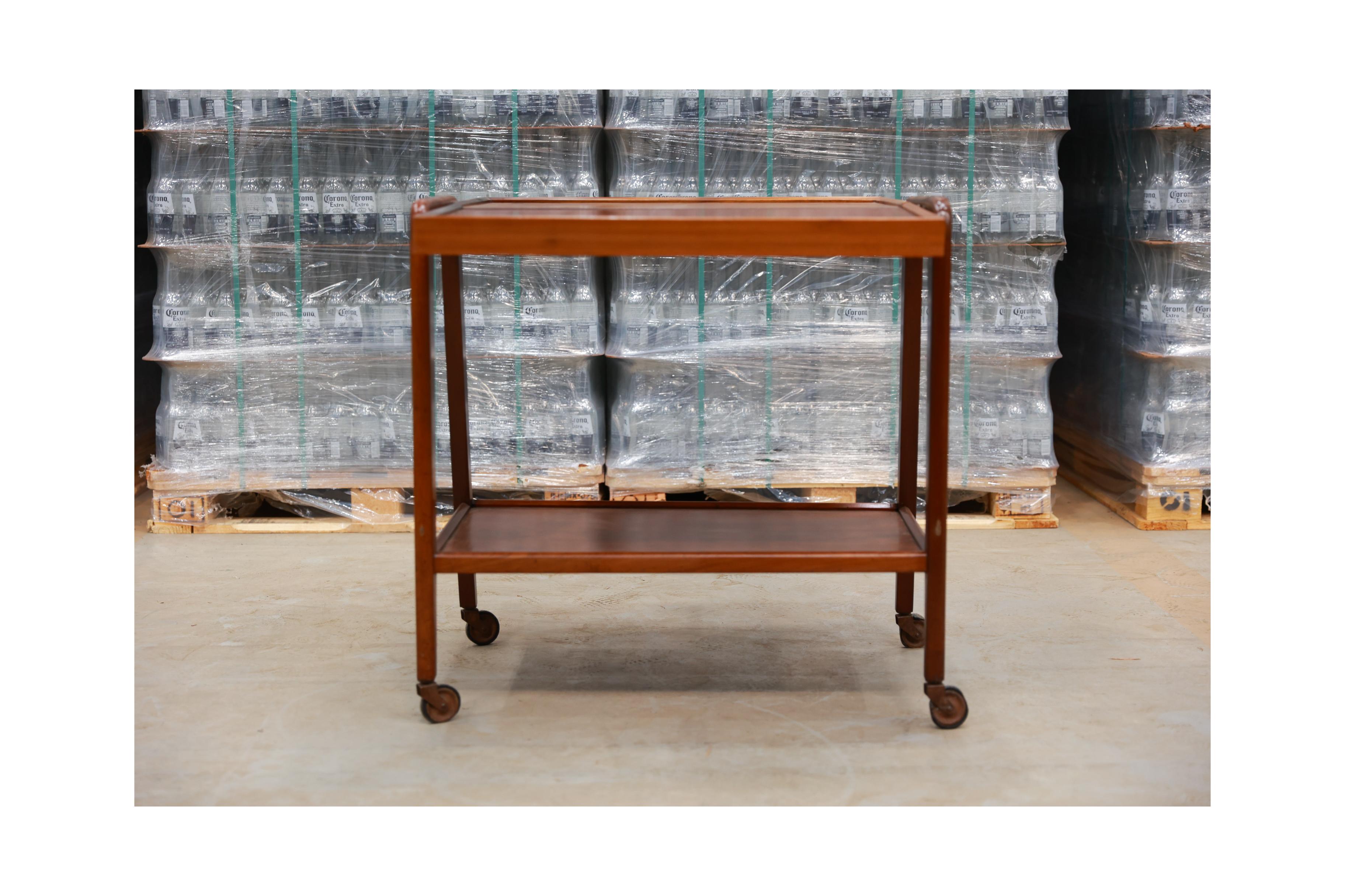 Available today, this Mid-century bar cart in Pau Marfim hardwood & brass is stunning! Its unique design, for the time, draws attention for its functionality and practicality. It has 3 different positions: Closed is an elegant bar with two levels.