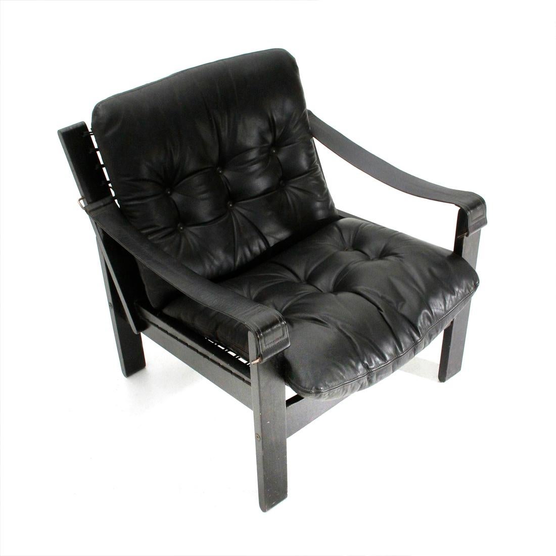 Norwegian-made armchair produced in the 1970s.
Black painted solid wood structure.
Black canvas seat on which the black leather stitched cushions with buttons rest.
Armrests in leather.
Good condition, some signs and lack of paint due to normal