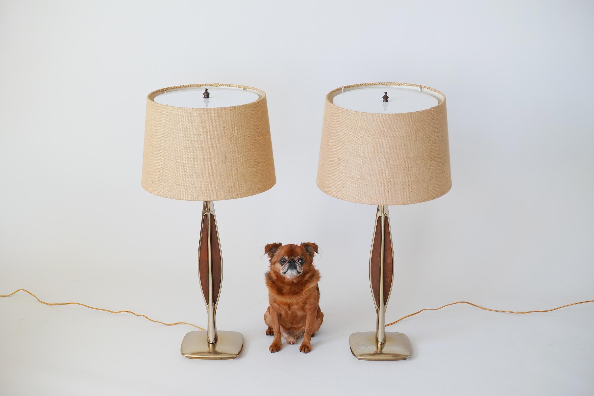 For your consideration is this handsome pair of 1960s Laurel lamps featuring fabric shades with acrylic top diffusers, sculptural brass bases with wood veneer inlays, and 3-way sockets. Handsome midcentury style and in good working order.