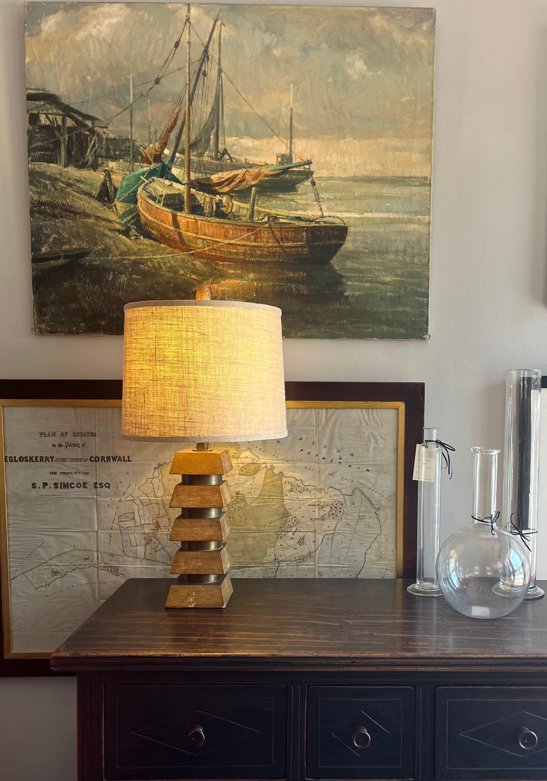 Midcentury modern wood and brass tiered lamp, outfitted with a contemporary naturalistic burlap shade and a fabulous wooden ellipsoid finial. Sleek yet organic, this unique 1970s desk or table lamp adds a note of warmth to any space. 

US, circa