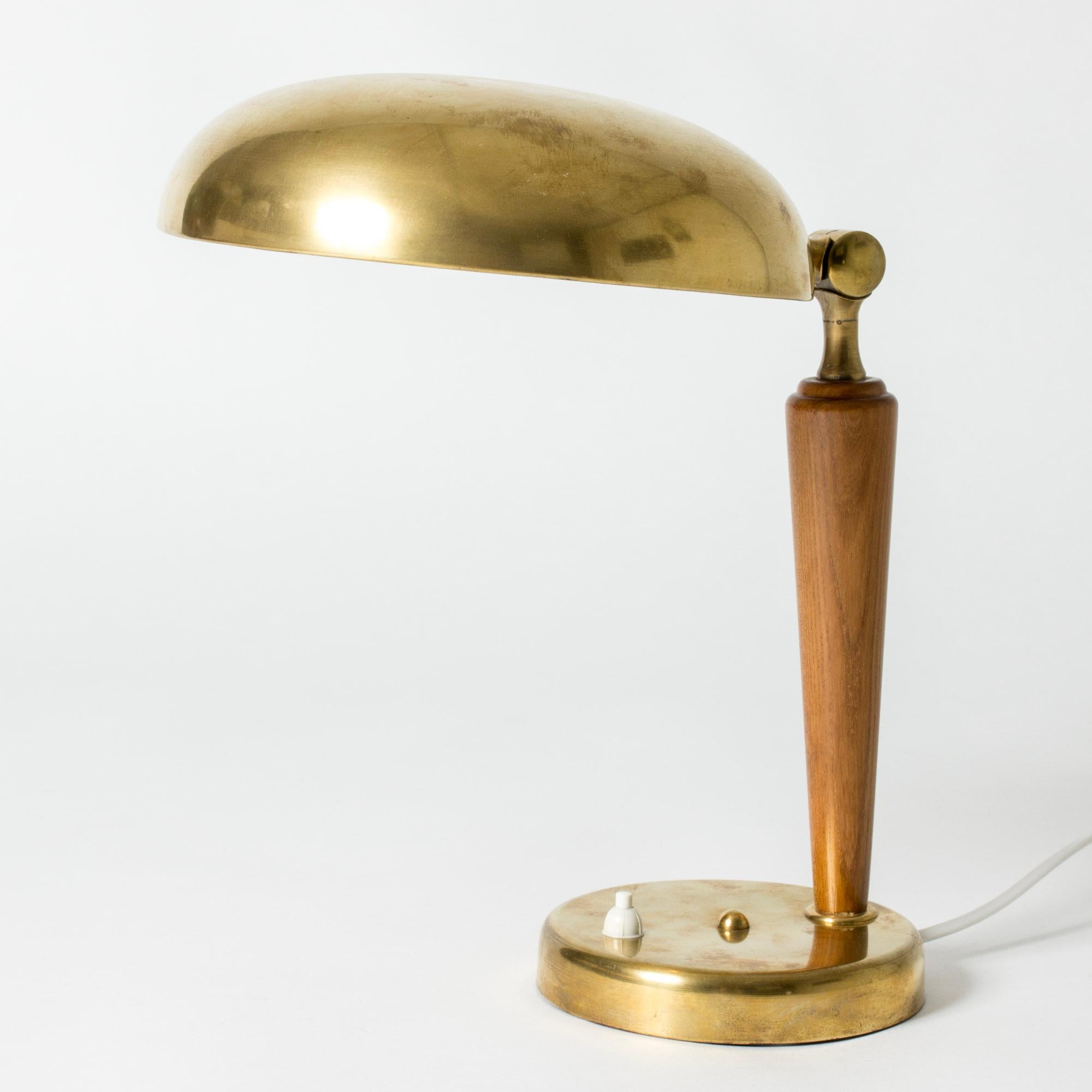 Cool Swedish Modern table or desk lamp, made from brass with a wood handle. Rounded, functionalist forms.