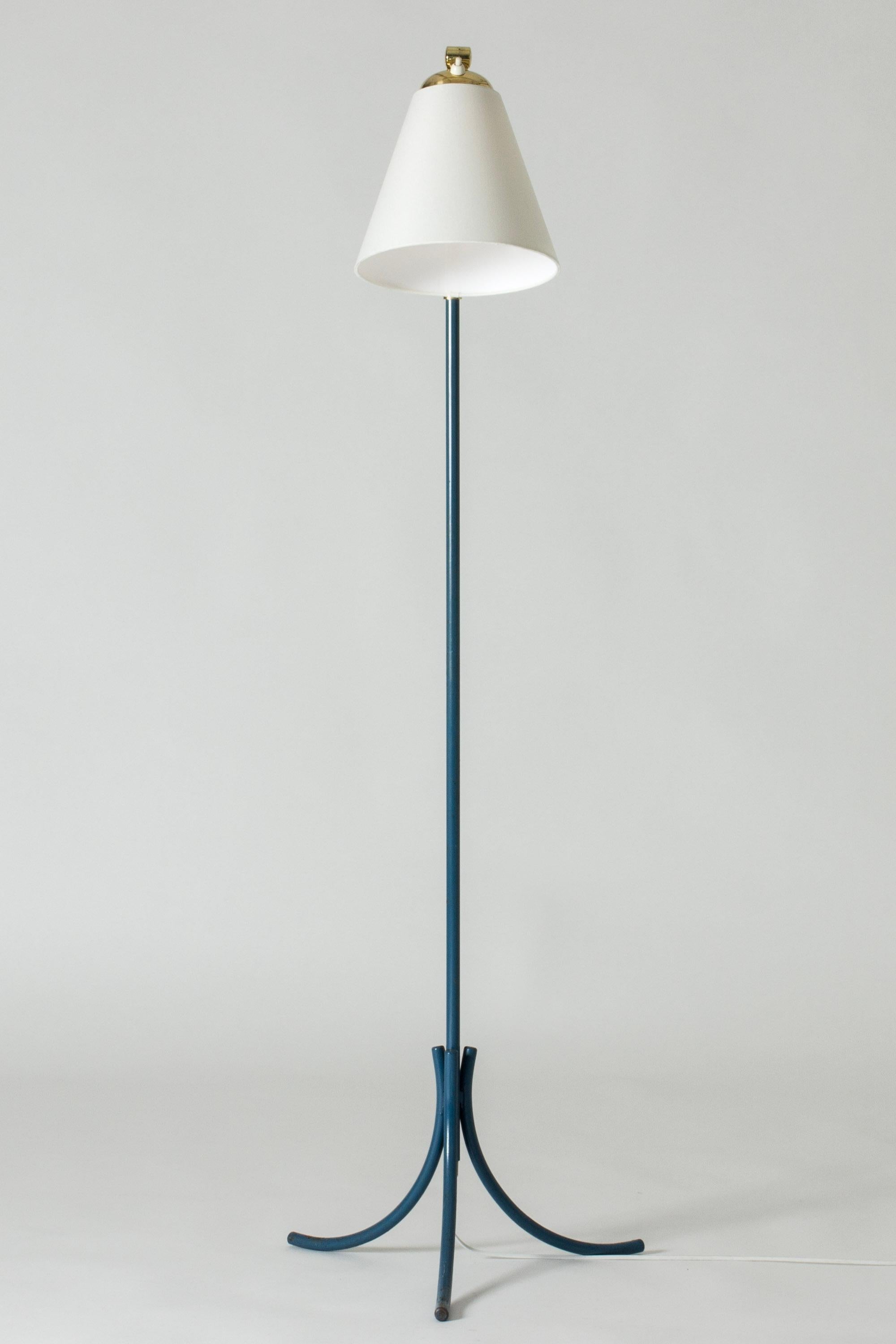 Elegant Swedish Modern floor lamp, made from brass. Stem partially lacquered in a nuance of blue, tripod base with curved forms.