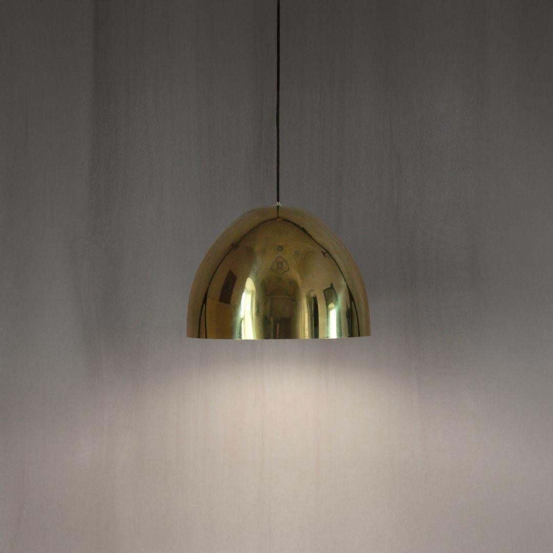 Brass Ceiling Pedant Lamp, Italy 1970s

This vintage brass pendant, manufactured in Italy during the 1960s-70s with an elegant and minimalist design. The lamp features a sleek hemispherical brass shape with a white enameled interior, which ensures a