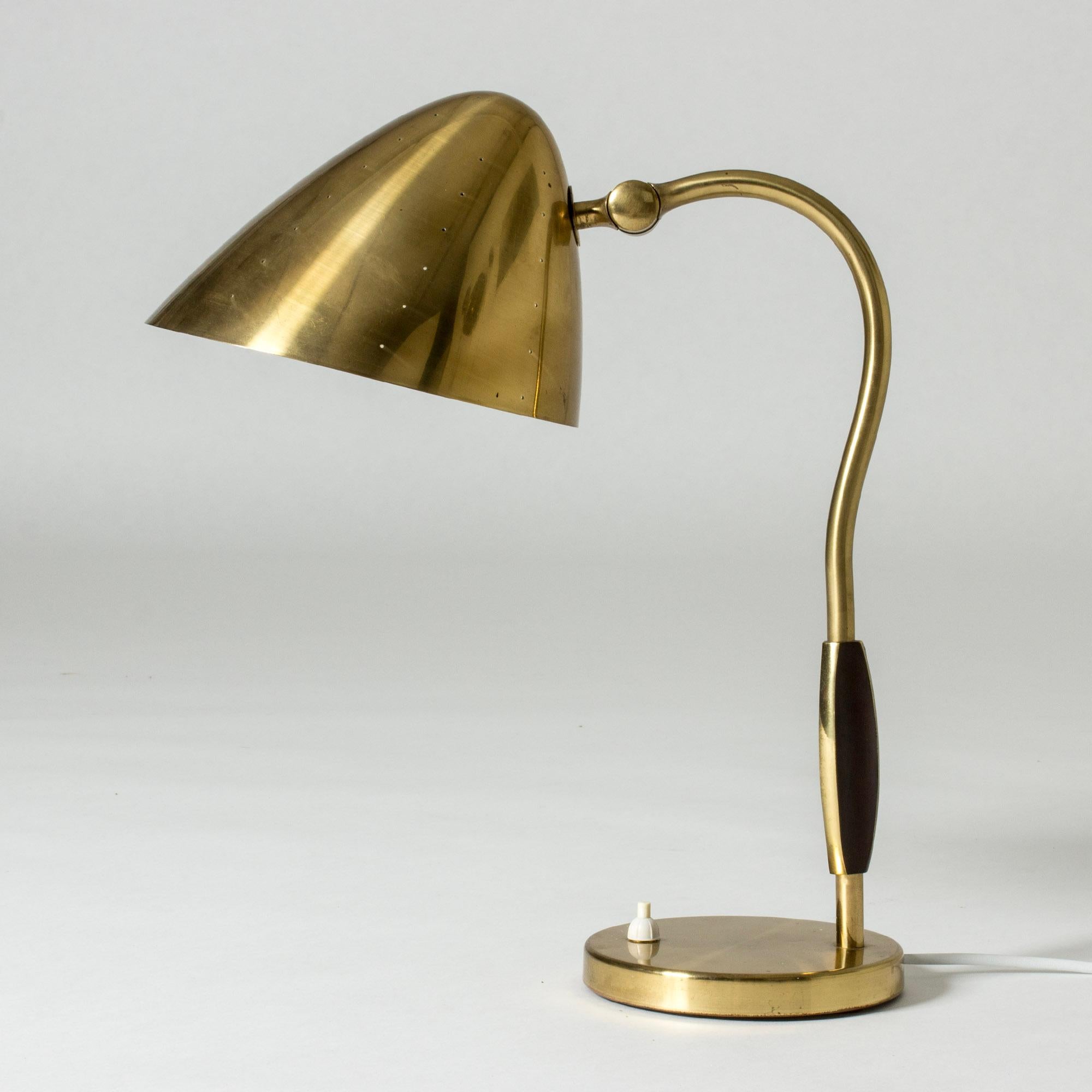 Elegant table or desk lamp from Boréns, made entirely from brass. Sculpted brass handle, shade perforated with small holes.