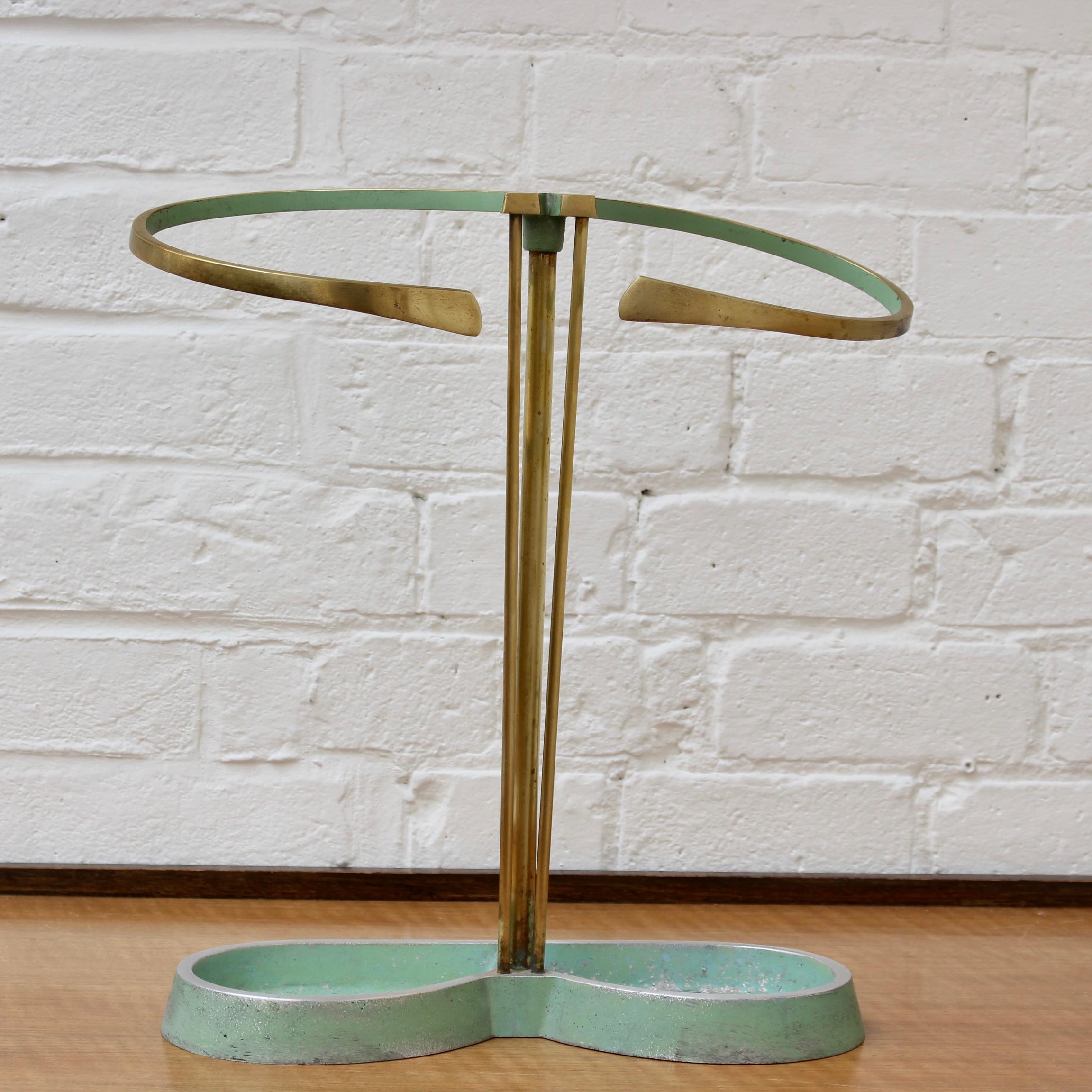 Elegant, Mid-Century Modern brass umbrella stand with cast aluminium foot (circa 1950s). Beautifully curvaceous design and charming pistachio green (not verdigris) highlights for those who love characterful Mid-Century vintage. This umbrella stand
