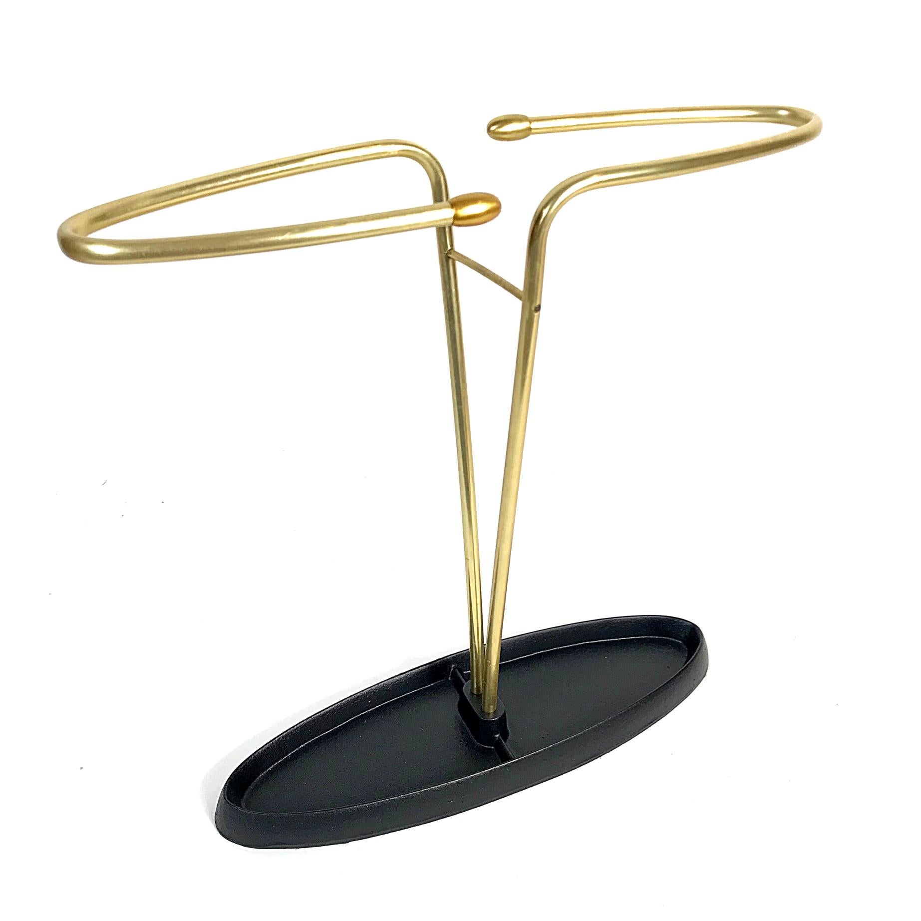 Simple and elegant midcentury umbrella stand manufactured in the 1950s, Austria. Black lacquered iron and brass.

We ship with DHL-Express.