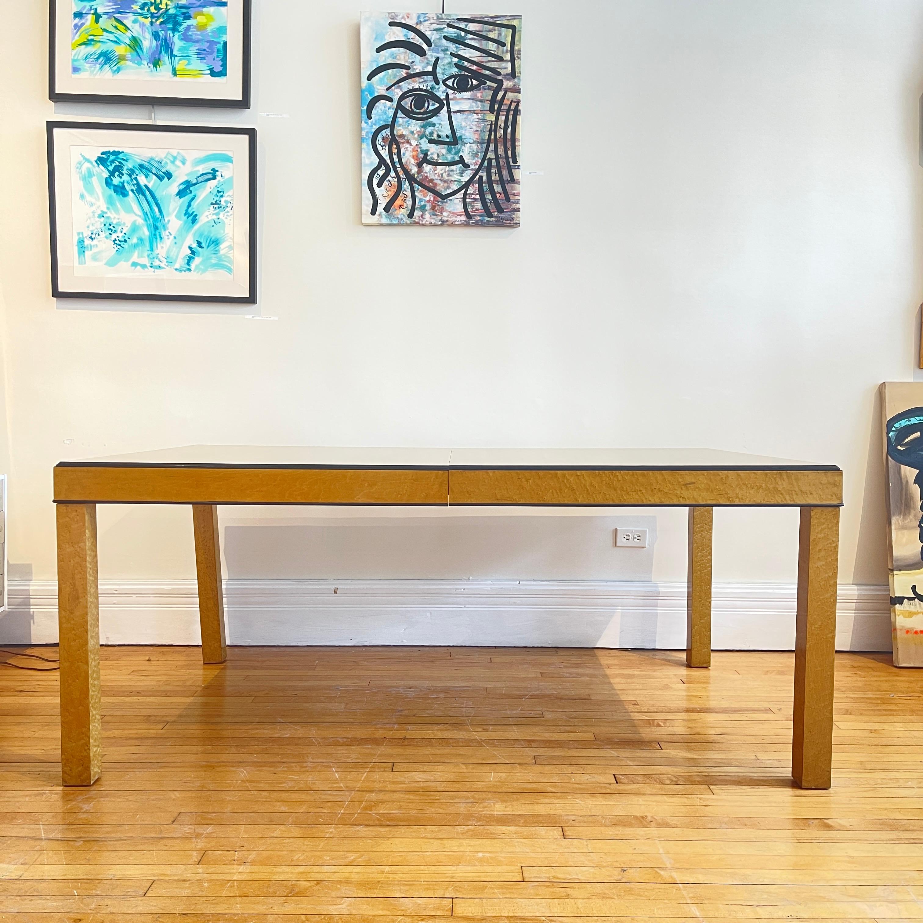 Freshly refinished extension Parsons dining table made of a beautiful burled wood. Black finished edge completes the look of this elegant piece.
70