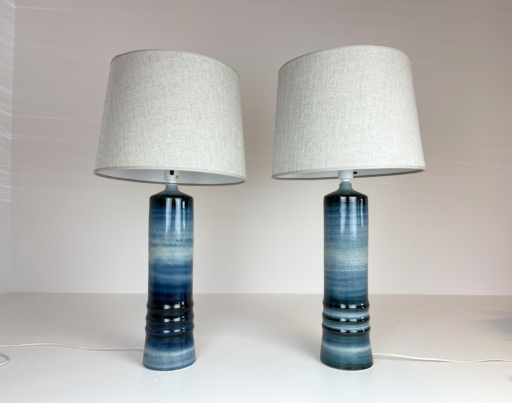 A pair of large, glazed stoneware table lamps by Olle Alberius for Rörstrand, Sweden, 1970s.
Signed on the base. The blue glaze is wonderful and gives a great shine when lit. One of the lamps has the original label. It’s rare to find a pair of