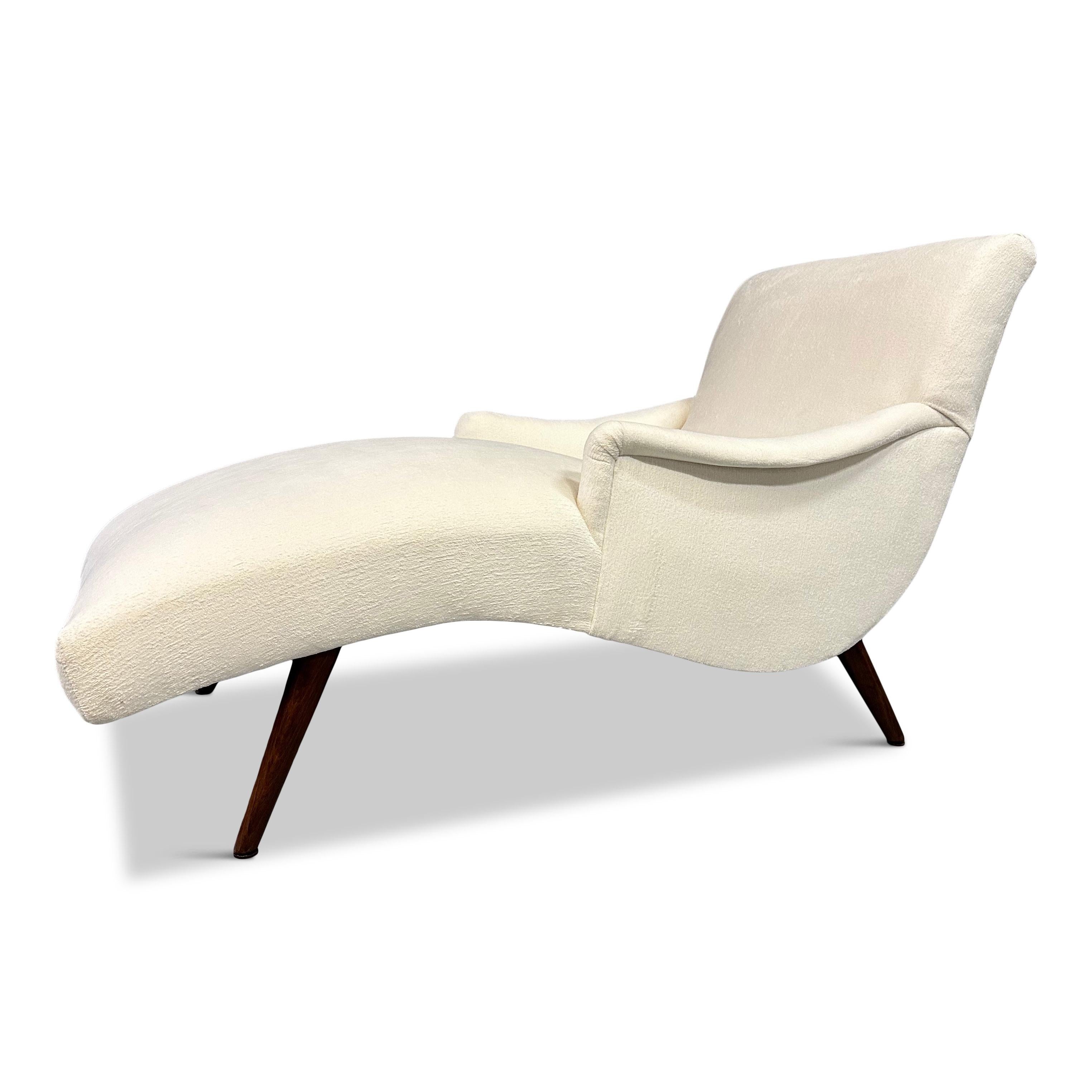 A gorgeous sleek chaise lounge from the 1950s. Newly reupholstered in a textured white velvet with walnut legs refinished in a lovely medium color.