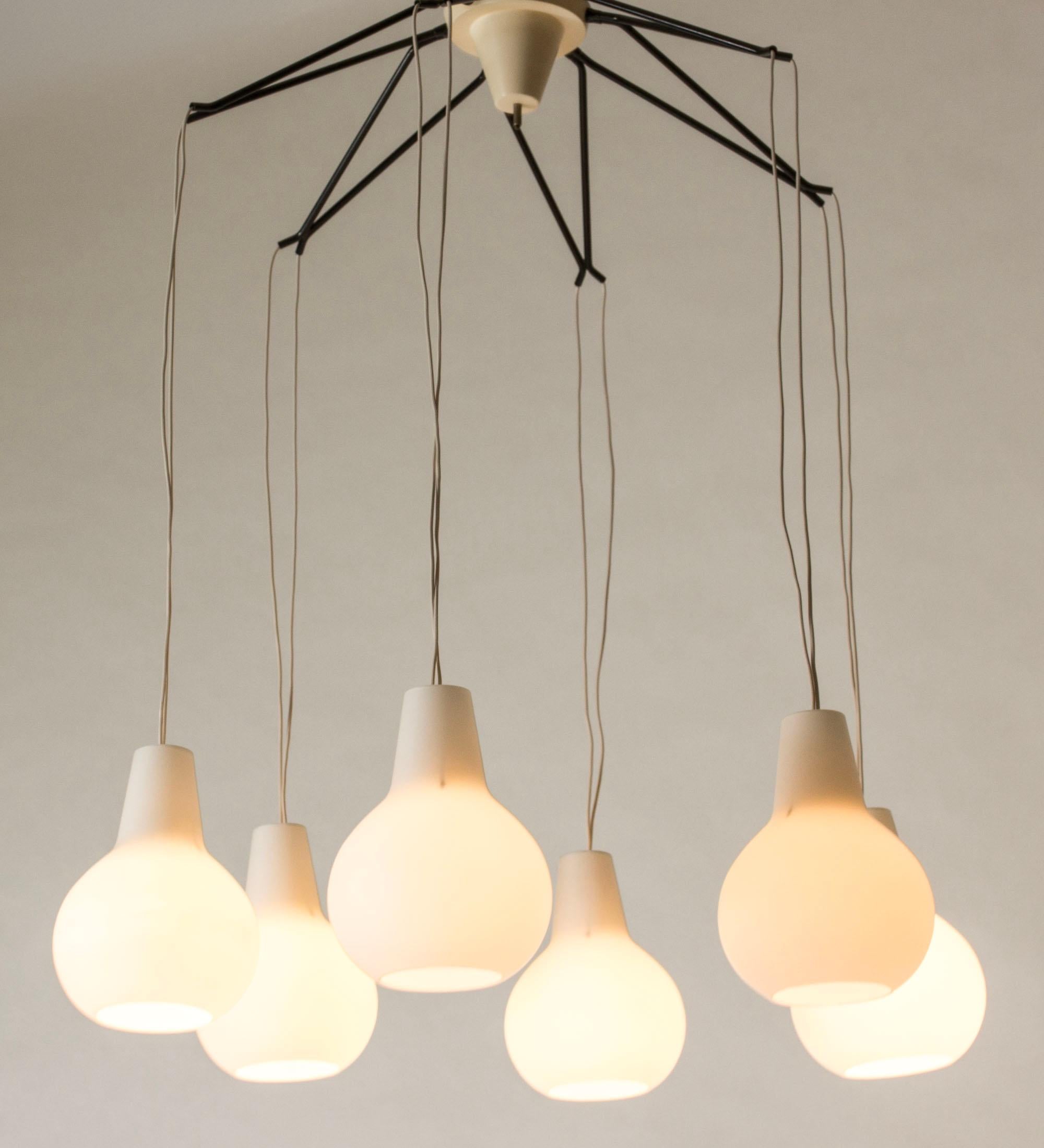Opaline glass and metal chandelier from ASEA in a cool, midcentury design. The six shades hang freely from the lacquered metal arms.
