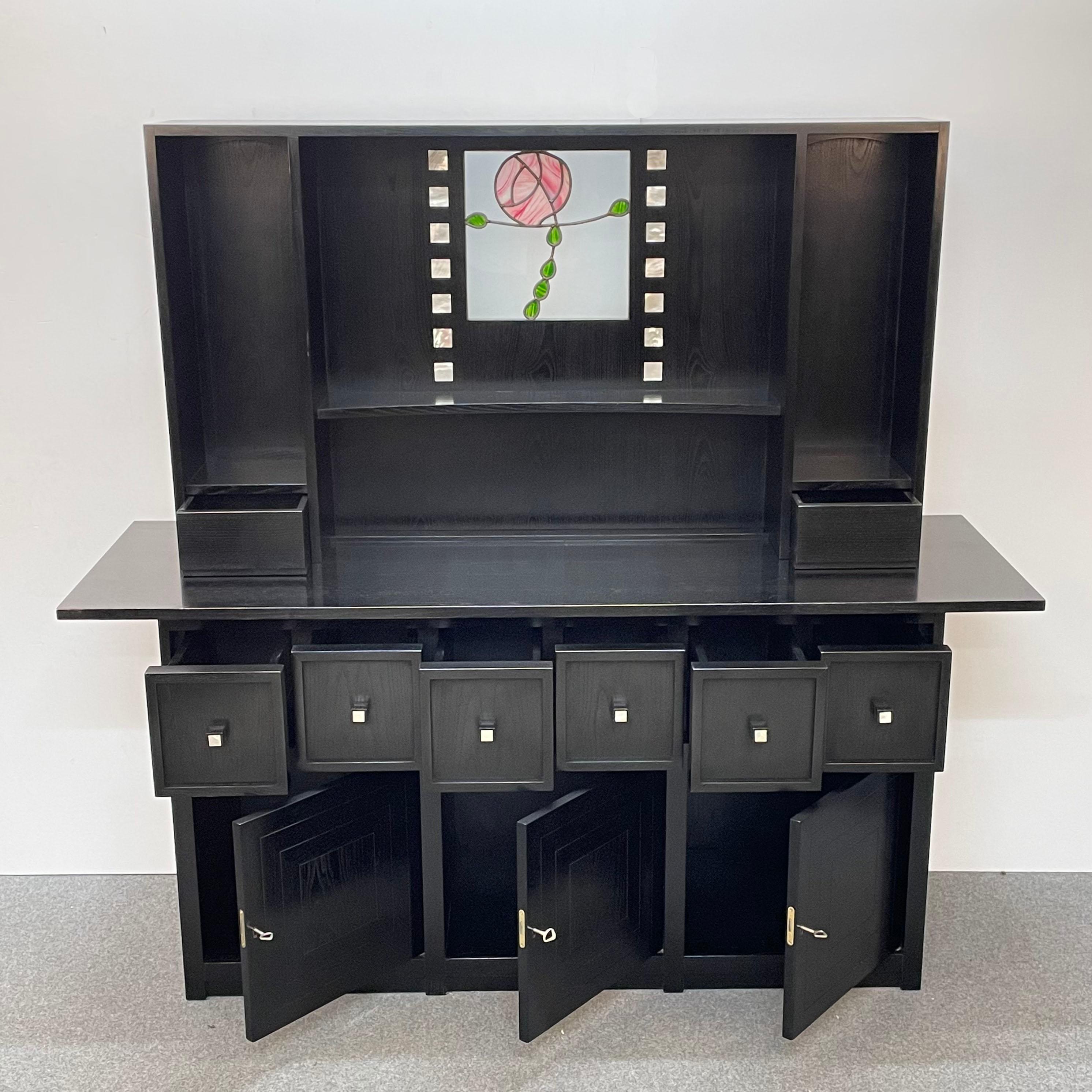Sideboard in open-pore black lacquered ash with incredible stunning inserts and decoration with leaded glass panel. This fantastic piece was designed by Charles Rennie Mackintosh during the 1980s.

This sideboard is part of a series of furniture