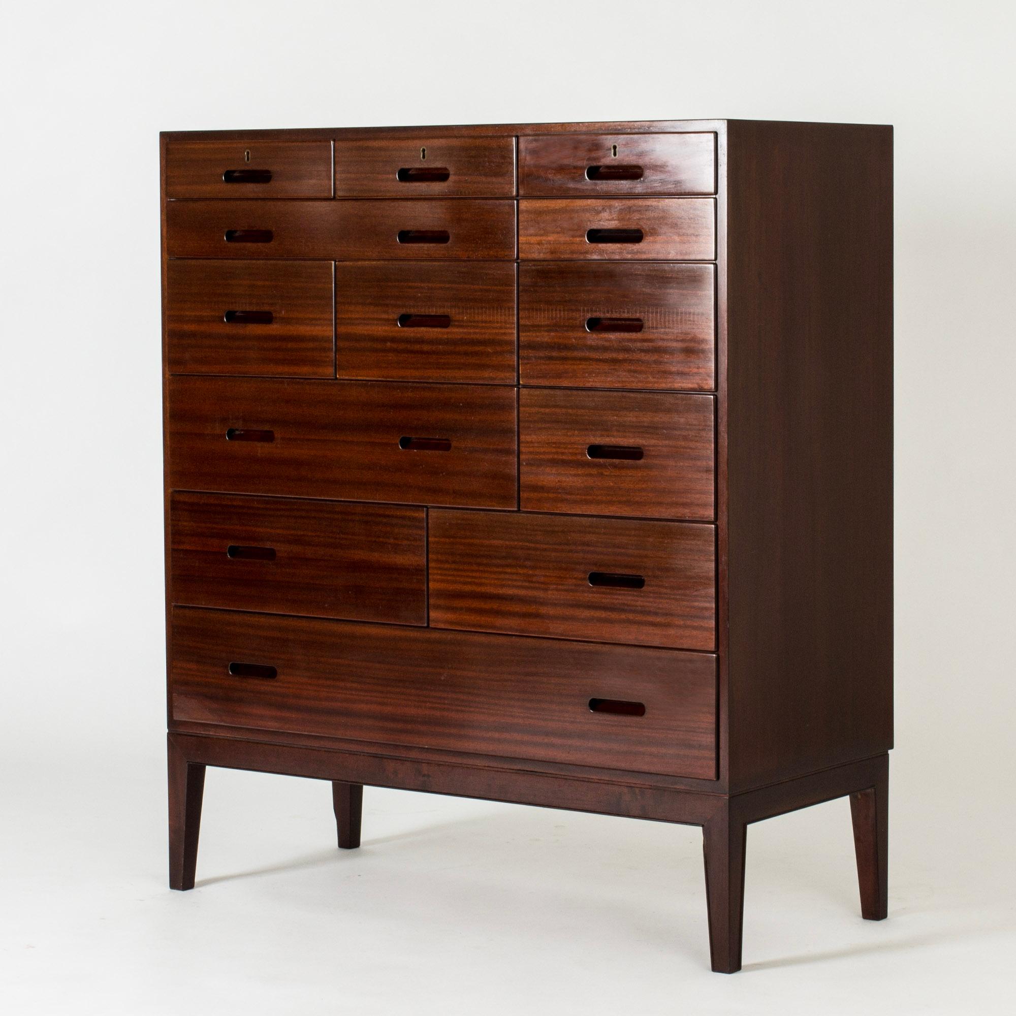 Striking chest of drawers by Kai Winding, made from rosewood. Large model with several drawers in different sizes, forming a cool pattern. Recessed drawer handles.