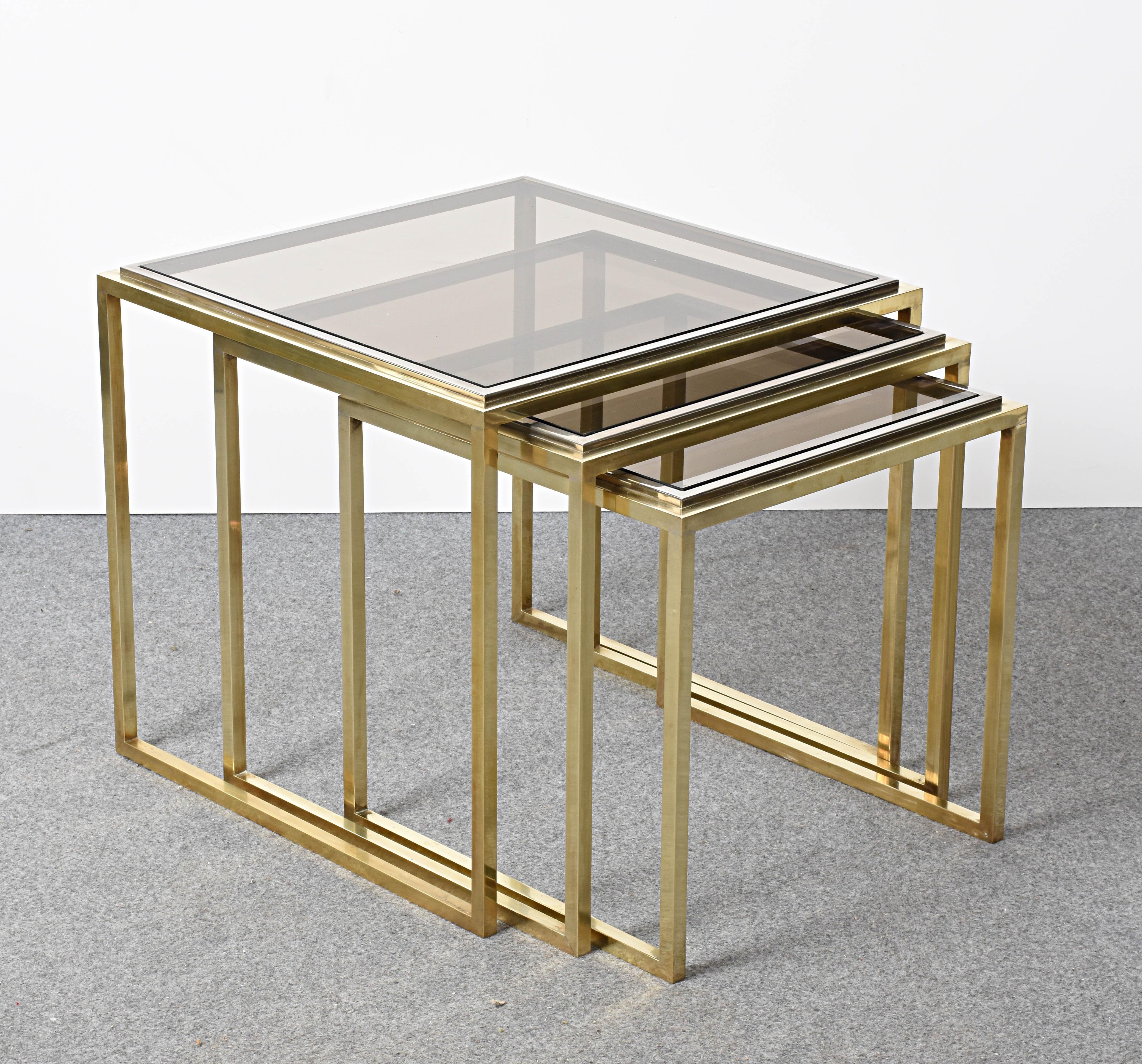 A wonderful set of three Nesting tables in chrome metal, brass and smoked glass.

It has all the Classic elements of Mid-Century Modern Italian production form the 1970s: clear lines, perfect material pairing and a perfect balance of elegance and