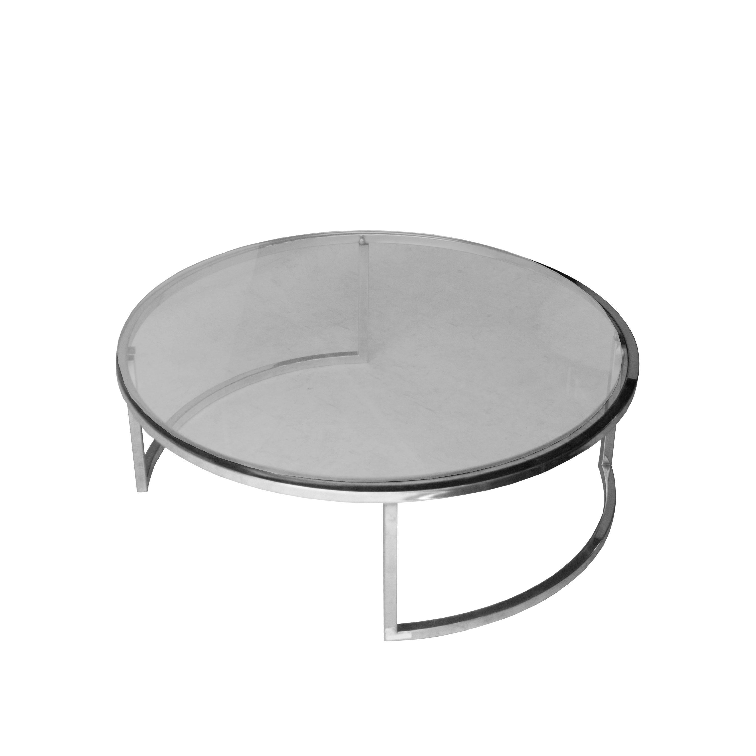 Circular coffee/center table with structure in chromed steel and glass top.
