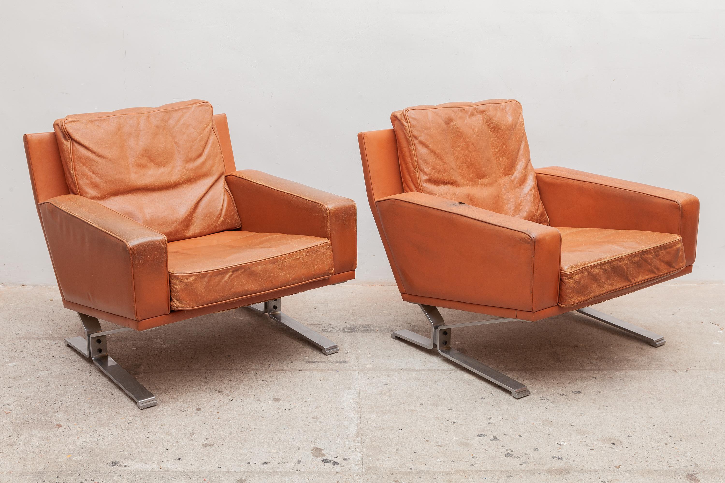 Vintage midcentury very nice club chairs. Patinated cognac leather. Wide comfortable seat and armrests. These high quality chairs are made of a massive stainless steel base.
Good nice patina to the leather, signs of wear and age but not rips.