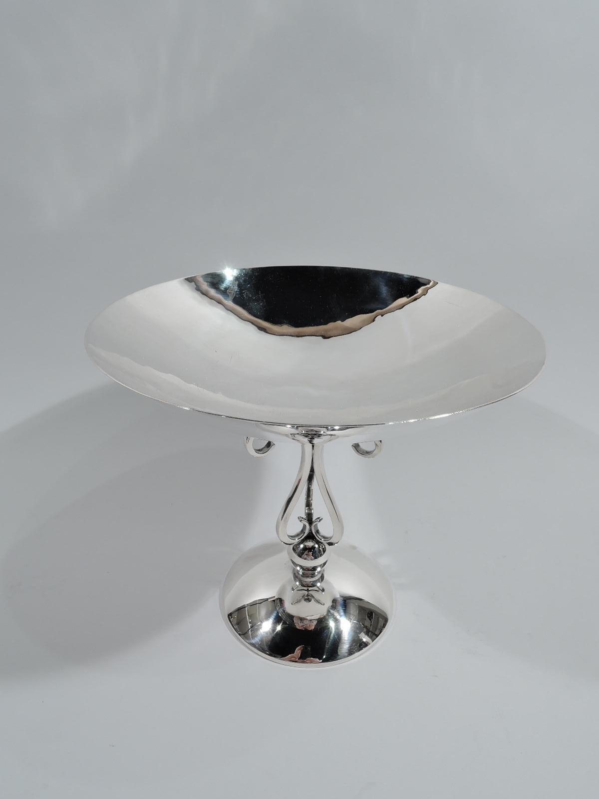Mid-Century Modern sterling silver compote. Made by Alfredo Sciarrotta in Newport. Round curved bowl on open support comprising 3 s-scroll supports mounted to ball on raised round foot. Fully marked including maker’s and retailer’s (Cartier) stamps,