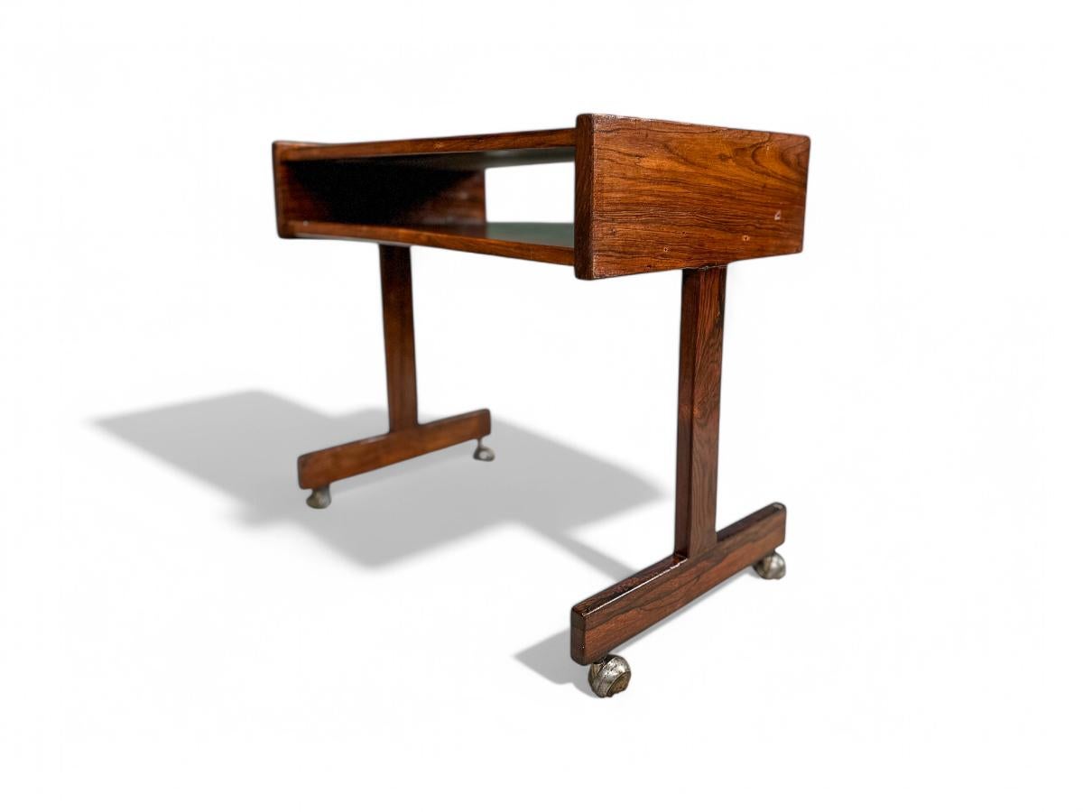 Available now, this Midcentury Modern Console & Chrome Wheels designed by Sergio Rodrigues in the sixties is beautiful.

The consoled has a structure made in solid Brazilian rosewood, as known as Jacaranda and Jacaranda leaf. The four wheels are