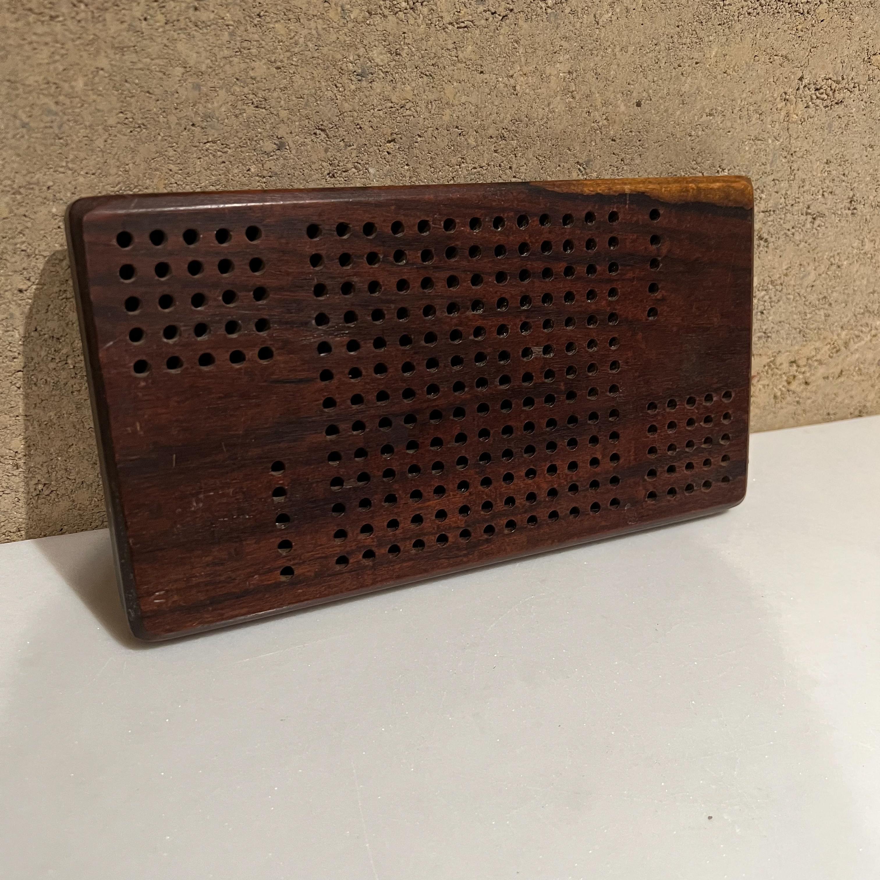 AMBIANIC presents
1960s Mid-Century Modern vintage rosewood cribbage game board 
For decorative purposes, we are selling the board only.
Measures: 10.25 Wide x 6. D x 1 Thick
Preowned original vintage unrestored condition, refer to images